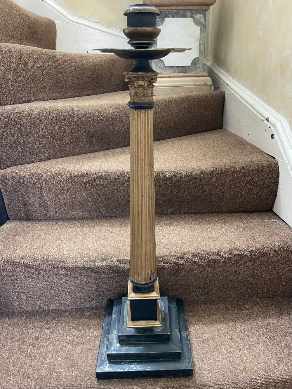 A set of three tall 19th-century graduated candlesticks featuring fluted gold-toned Corinthian columns on black stepped bases. View III