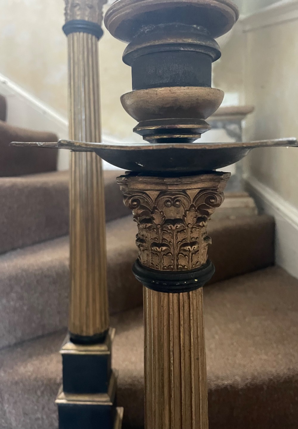 A set of three tall 19th-century graduated candlesticks featuring fluted gold-toned Corinthian columns on black stepped bases. View VIII