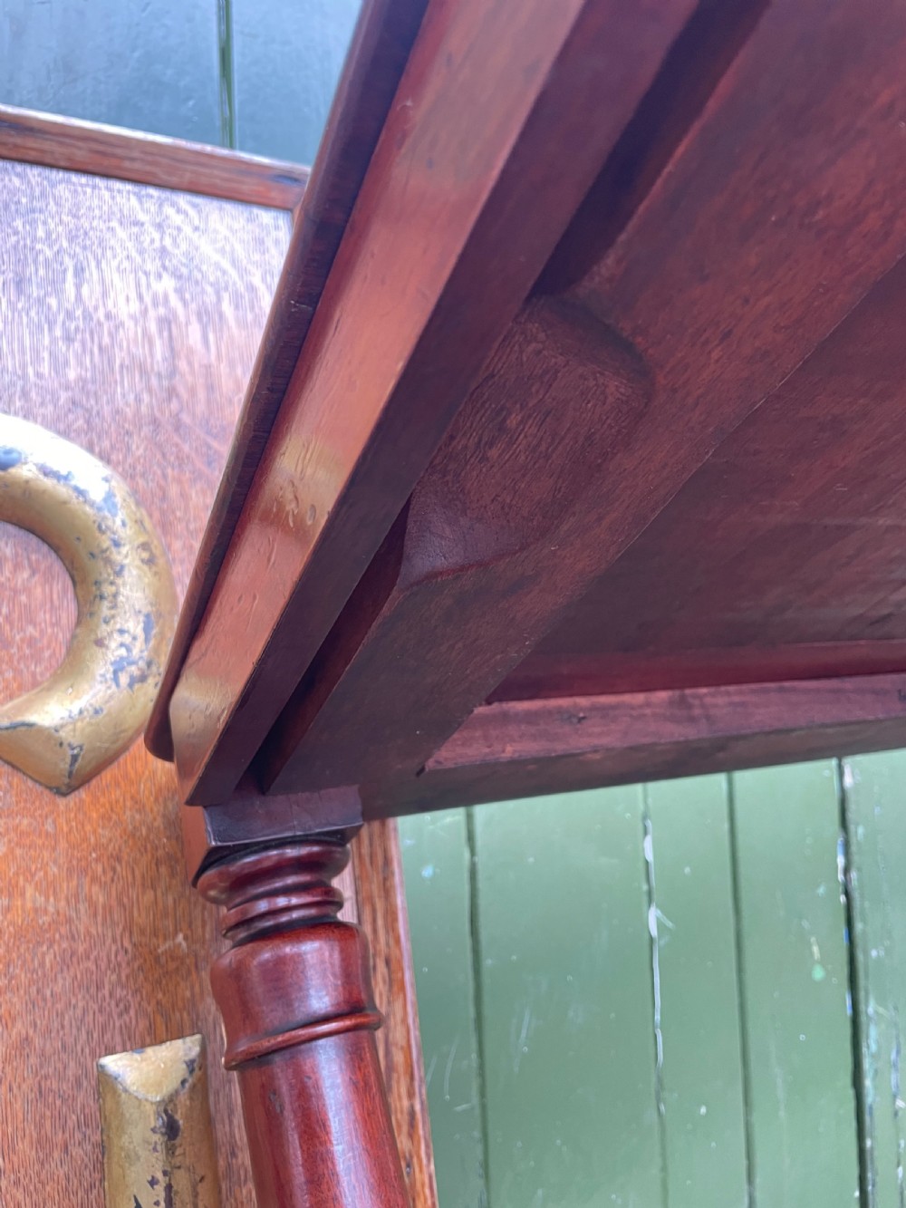A three-tier George IV mahogany buffet table featuring turned column supports and brass castors. View XV