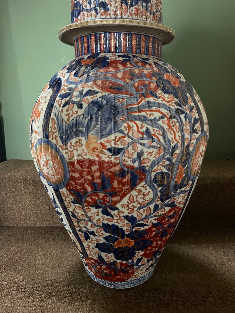A large Japanese Meiji period porcelain covered vase featuring fluted sides and painted in underglaze blue and iron-red Imari patterns with floral motifs. View XIII