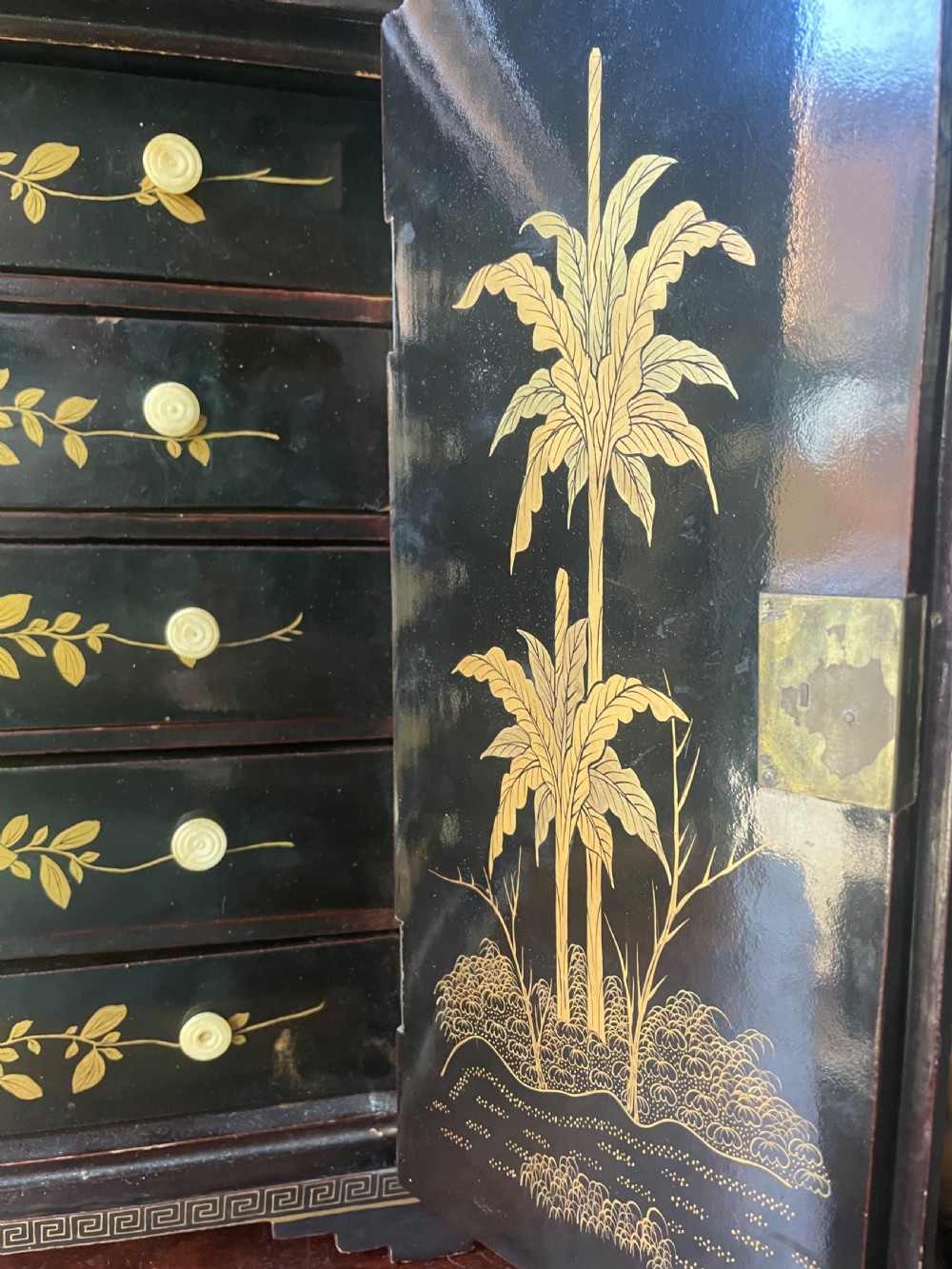 A mid-nineteenth century Chinese export black lacquer table cabinet featuring two doors decorated with gilded figural landscapes, floral borders, and geometric motifs. View VI