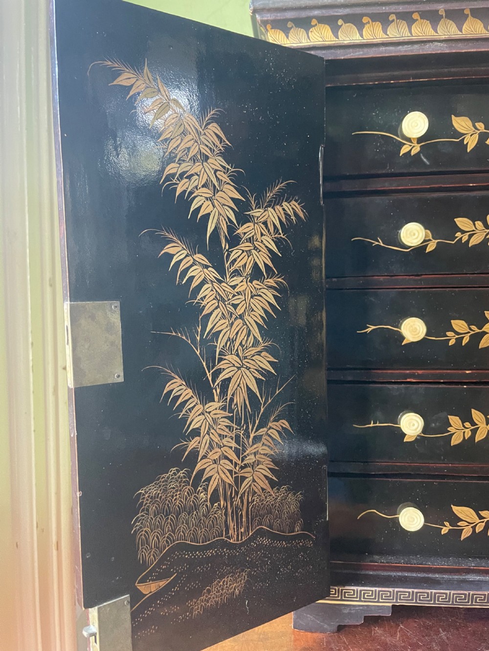 A mid-nineteenth century Chinese export black lacquer table cabinet featuring two doors decorated with gilded figural landscapes, floral borders, and geometric motifs. View VII