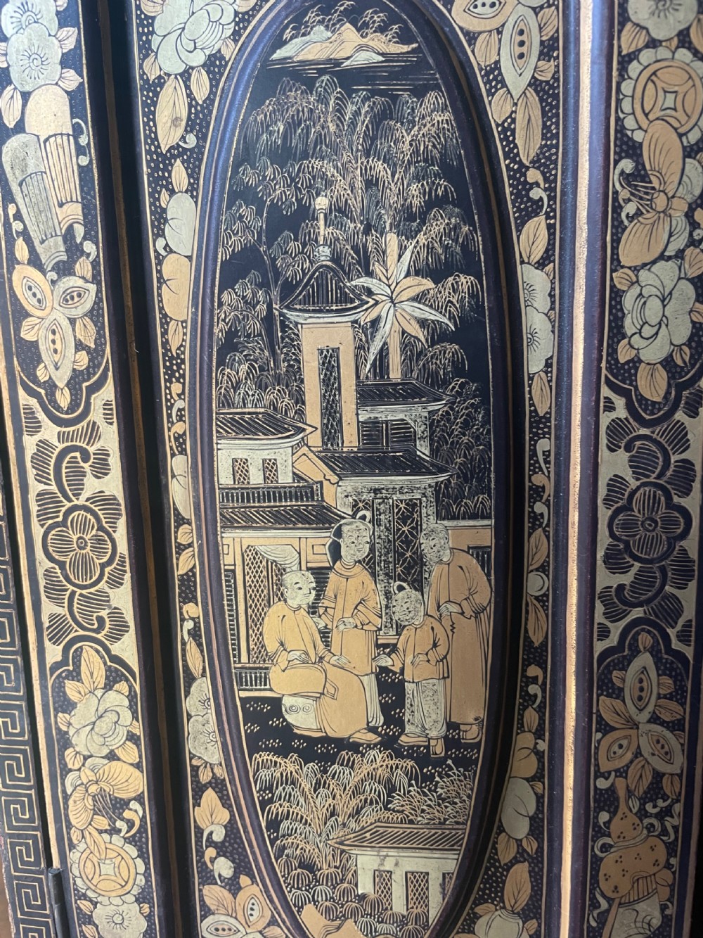 A mid-nineteenth century Chinese export black lacquer table cabinet featuring two doors decorated with gilded figural landscapes, floral borders, and geometric motifs. View VIII