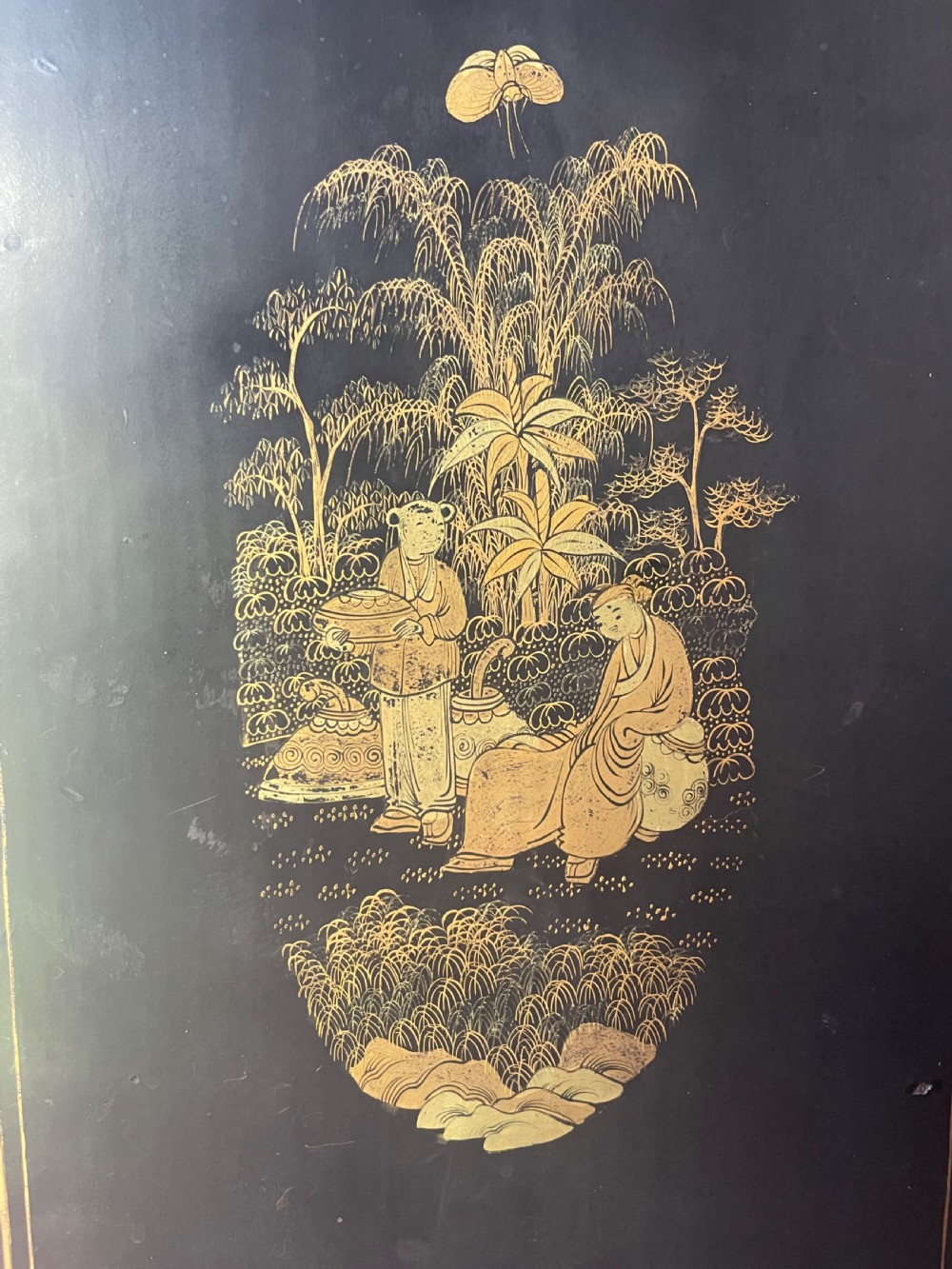A mid-nineteenth century Chinese export black lacquer table cabinet featuring two doors decorated with gilded figural landscapes, floral borders, and geometric motifs. View XII