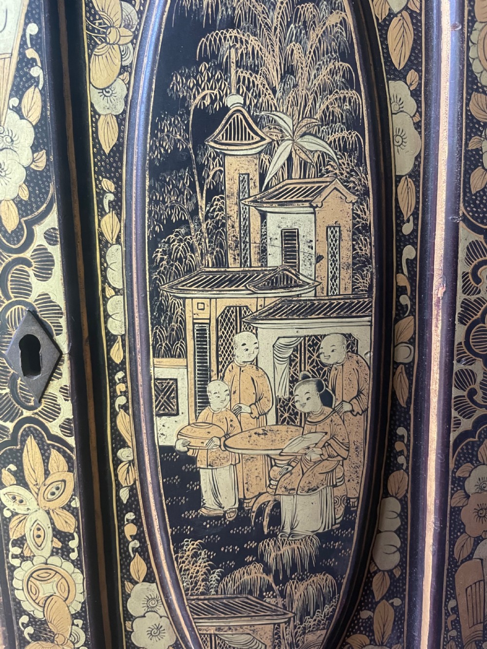 A mid-nineteenth century Chinese export black lacquer table cabinet featuring two doors decorated with gilded figural landscapes, floral borders, and geometric motifs. View XV