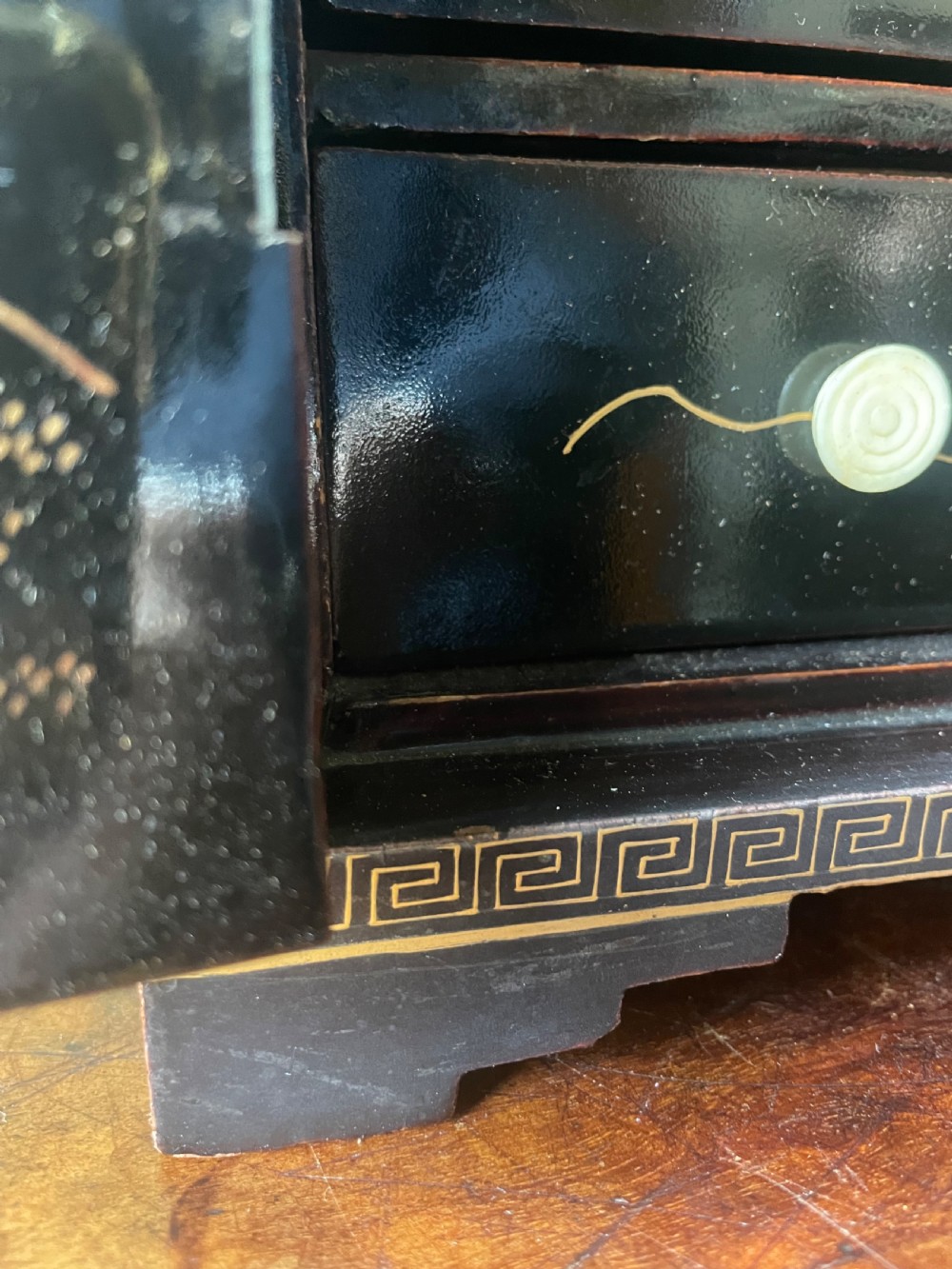 A mid-nineteenth century Chinese export black lacquer table cabinet featuring two doors decorated with gilded figural landscapes, floral borders, and geometric motifs. View XX