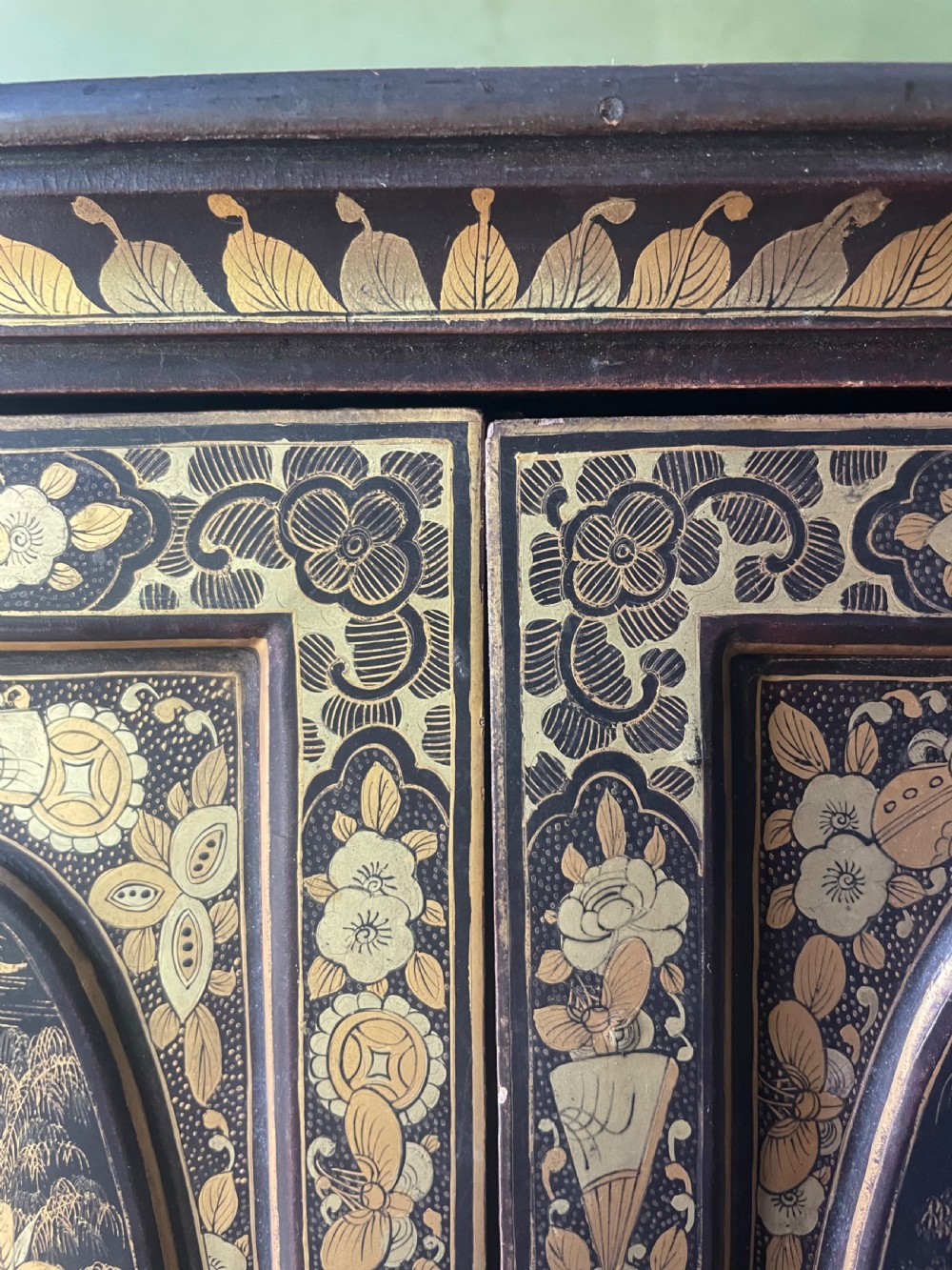 A mid-nineteenth century Chinese export black lacquer table cabinet featuring two doors decorated with gilded figural landscapes, floral borders, and geometric motifs. View XXIII
