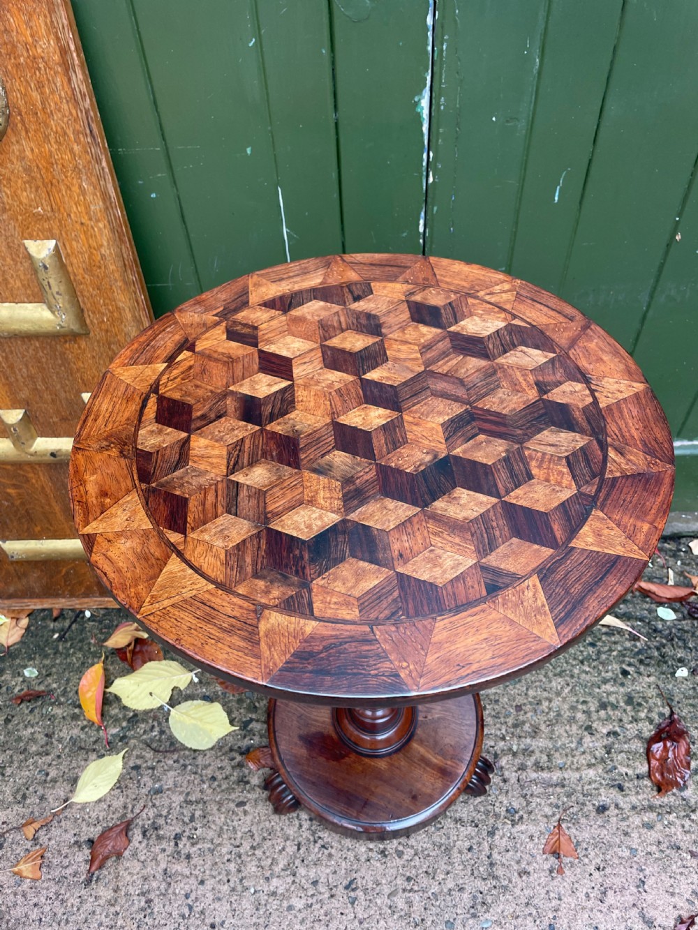 A 19th-century William IV circular occasional table featuring a geometric optical parquetry top set on a turned column stem and plinth base. View II