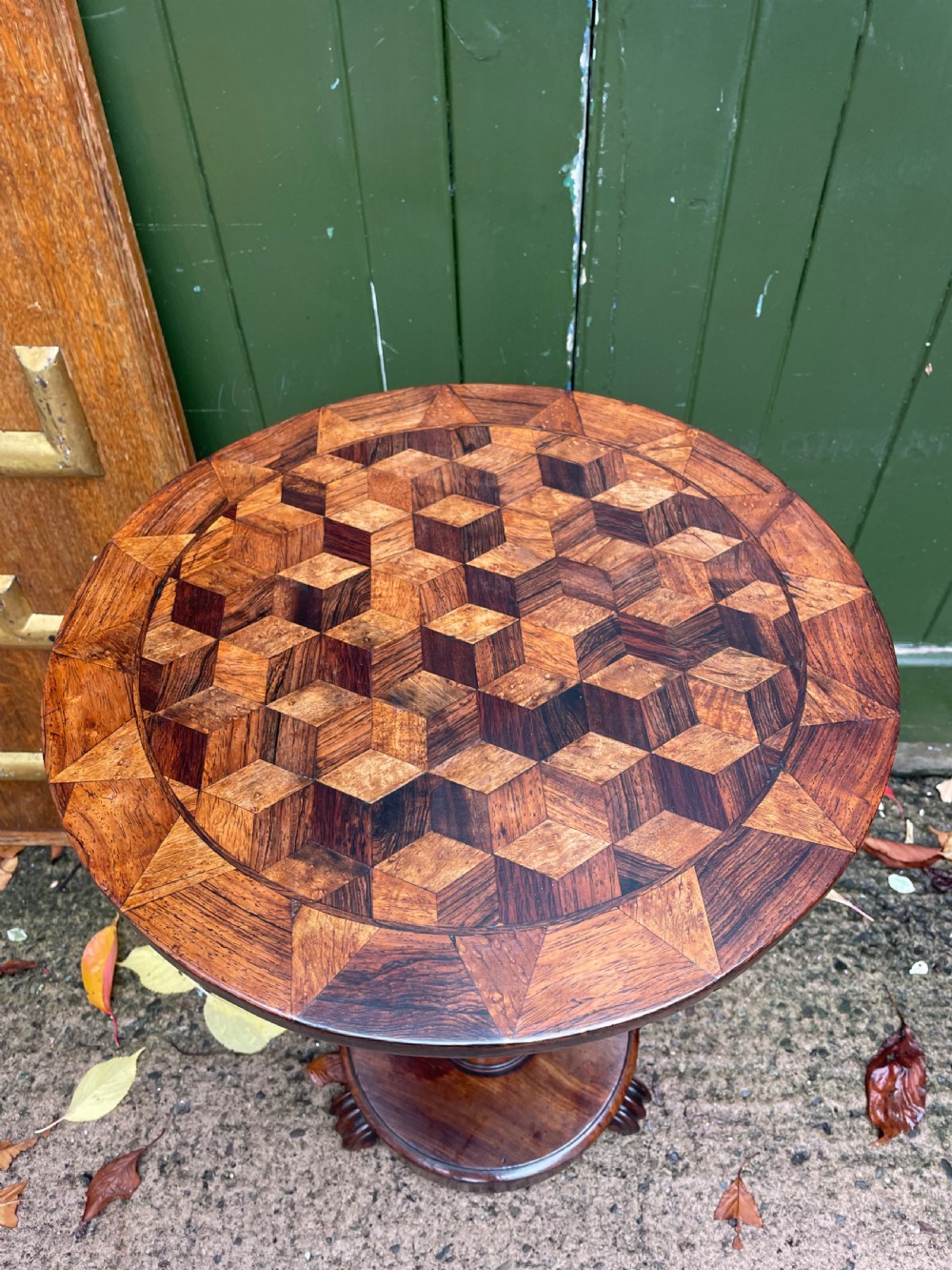 A 19th-century William IV circular occasional table featuring a geometric optical parquetry top set on a turned column stem and plinth base. View III