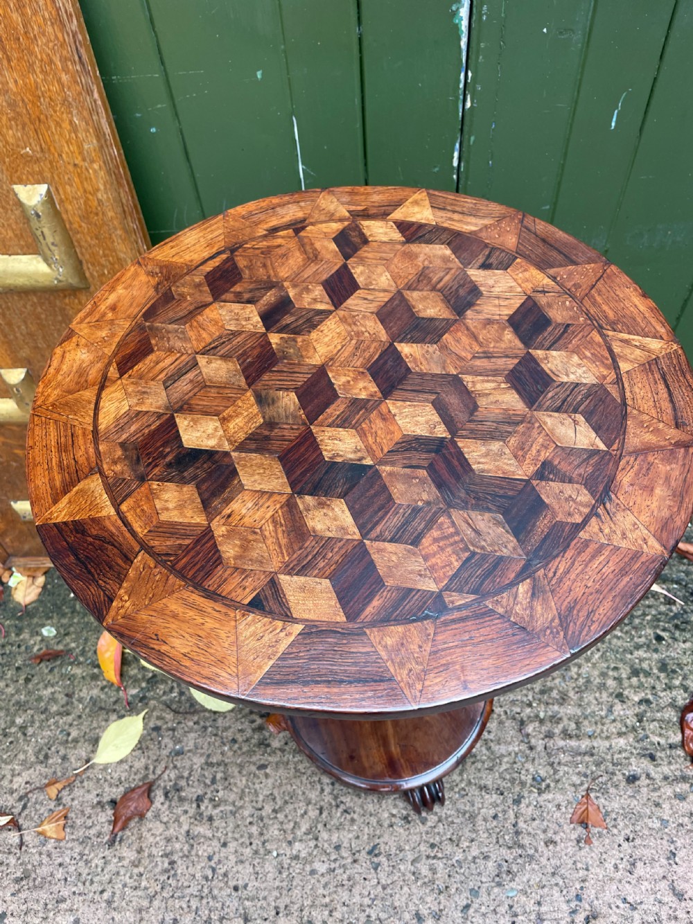A 19th-century William IV circular occasional table featuring a geometric optical parquetry top set on a turned column stem and plinth base. View VIII