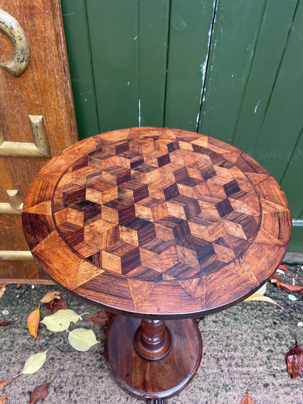 A 19th-century William IV circular occasional table featuring a geometric optical parquetry top set on a turned column stem and plinth base. View X