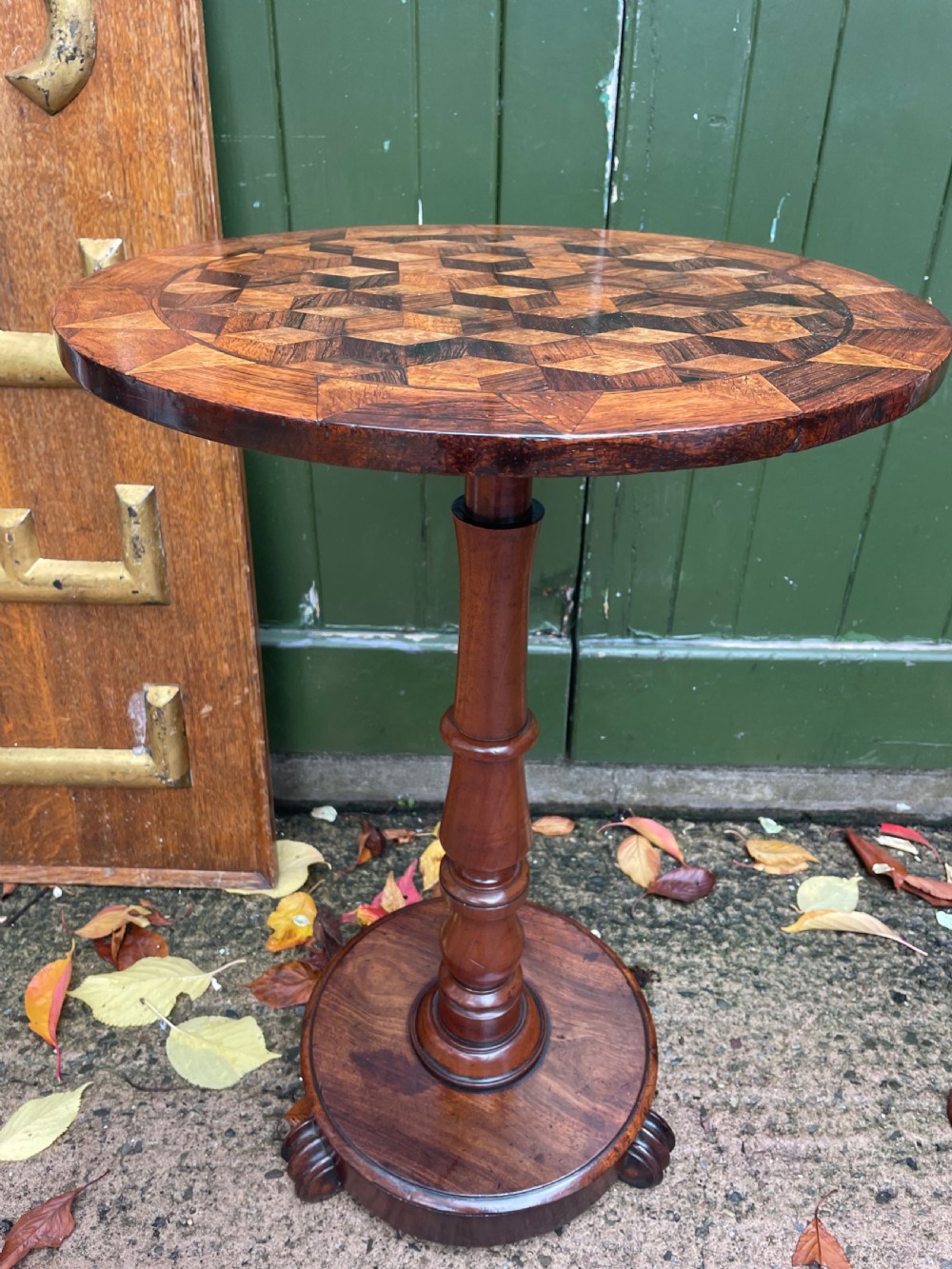 A 19th-century William IV circular occasional table featuring a geometric optical parquetry top set on a turned column stem and plinth base. View XII