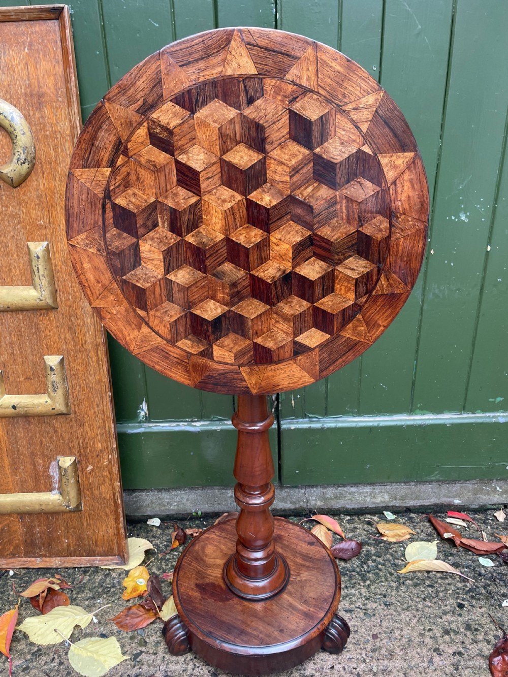 A 19th-century William IV circular occasional table featuring a geometric optical parquetry top set on a turned column stem and plinth base. View XV
