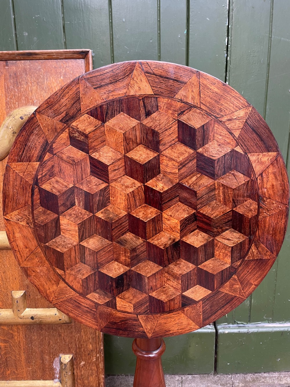 A 19th-century William IV circular occasional table featuring a geometric optical parquetry top set on a turned column stem and plinth base. View XIX