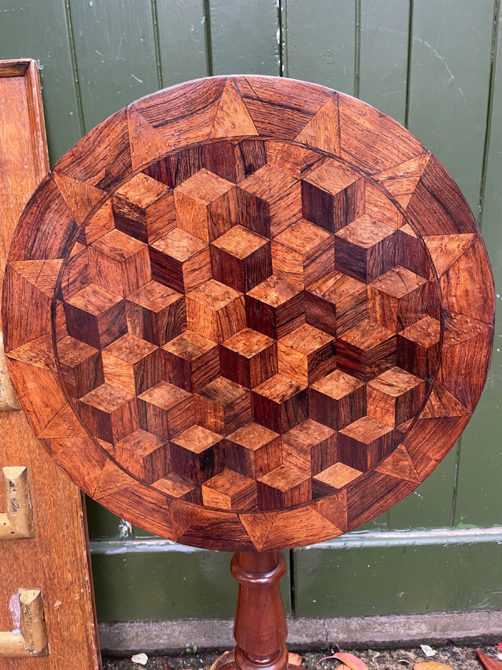 A 19th-century William IV circular occasional table featuring a geometric optical parquetry top set on a turned column stem and plinth base. View XX