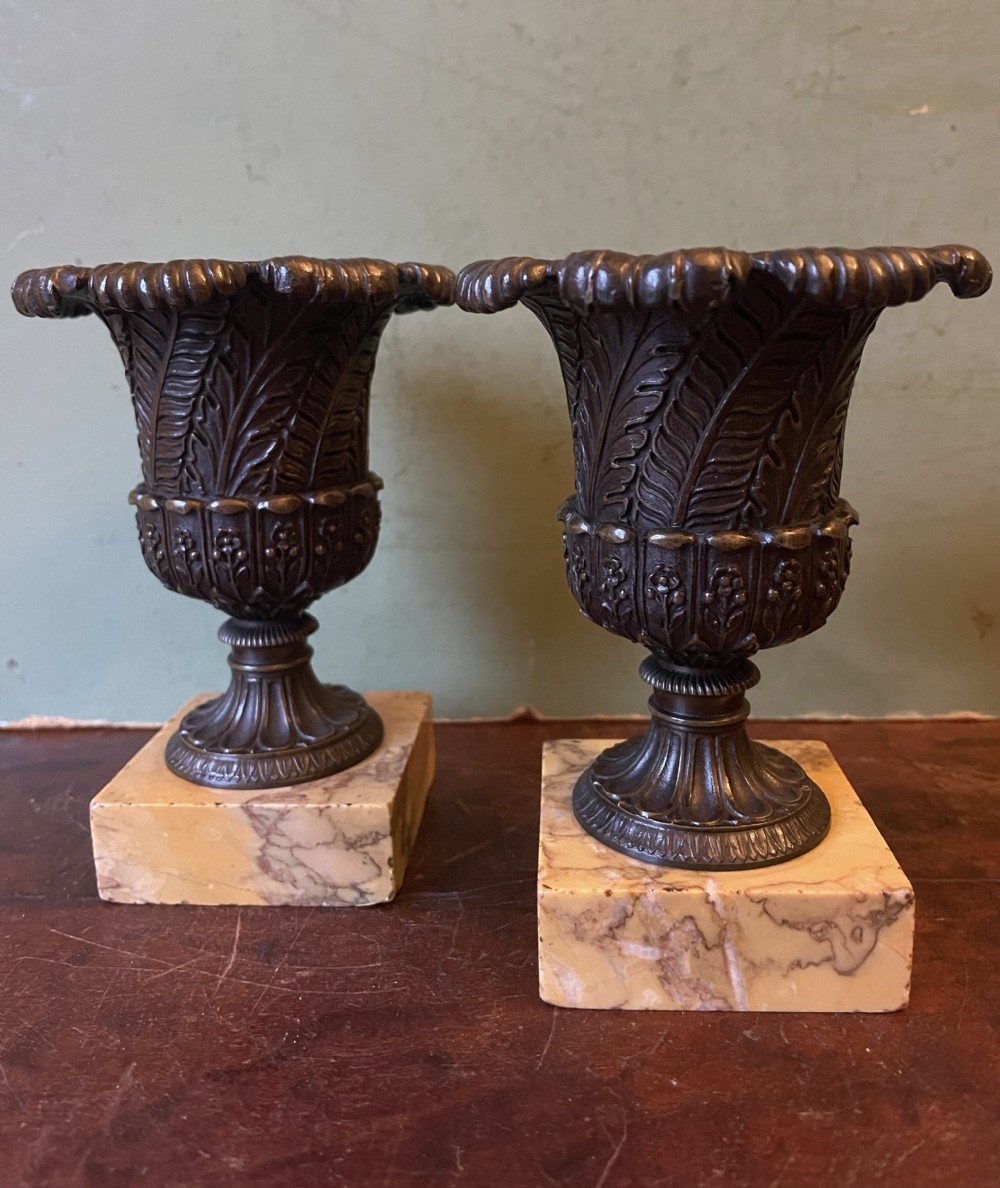 Finely cast pair of early C19th small-scale bronze classical campana-shaped vases on ‘giallo di siena’ marble block bases .