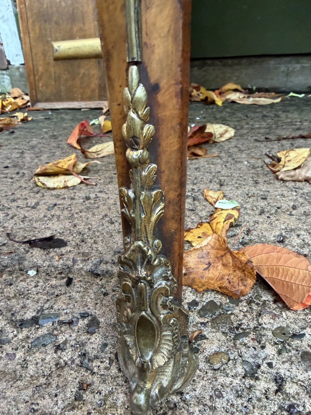 A mid-19th-century kidney-shaped burr walnut writing table with an inset leather surface and cast ormolu mounts on cabriole legs. View V