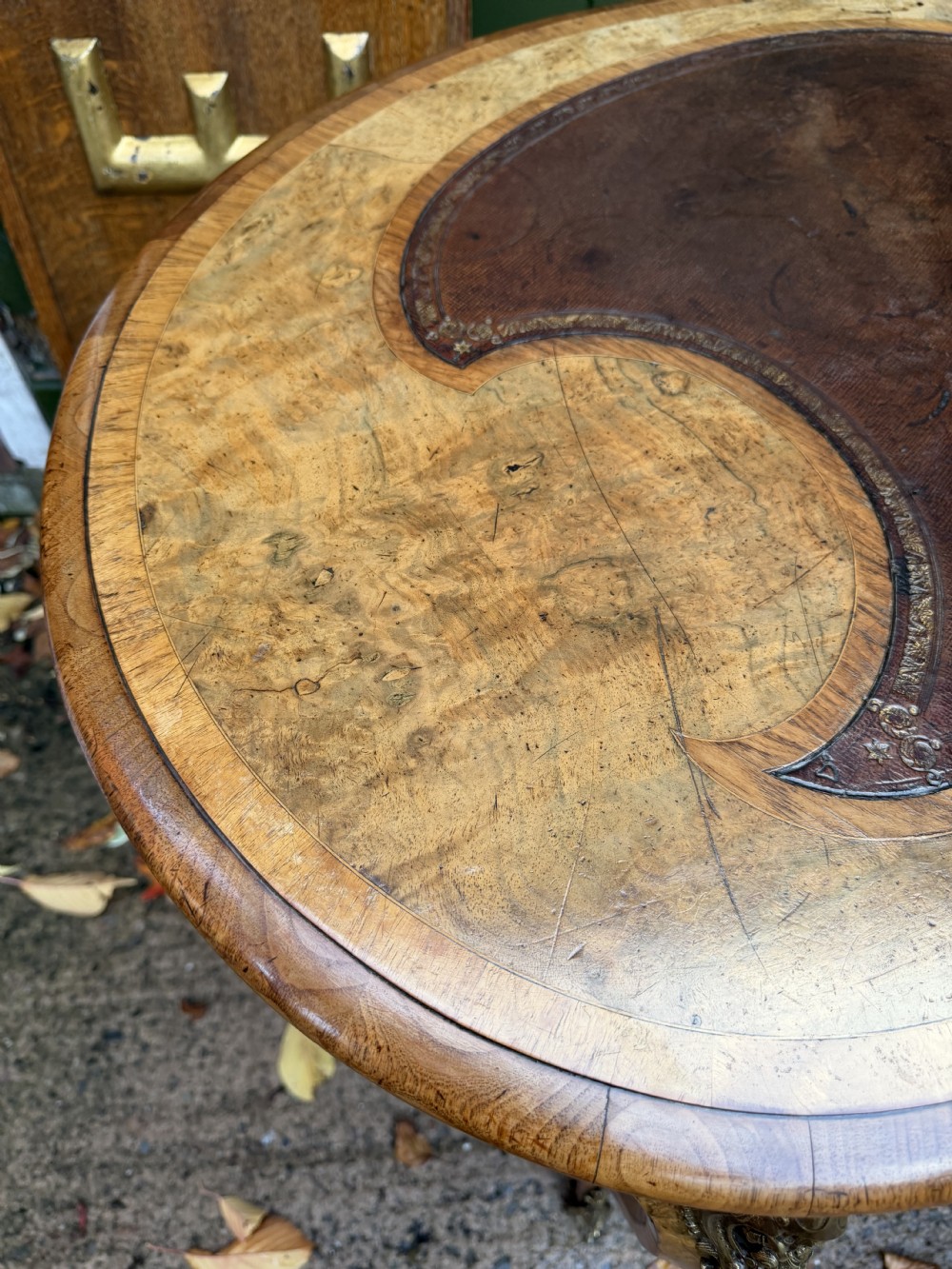 A mid-19th-century kidney-shaped burr walnut writing table with an inset leather surface and cast ormolu mounts on cabriole legs. View VII