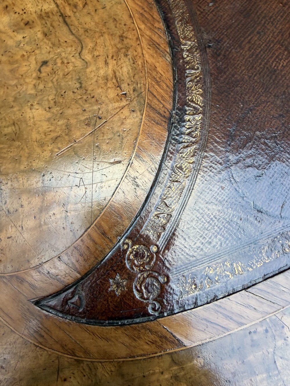A mid-19th-century kidney-shaped burr walnut writing table with an inset leather surface and cast ormolu mounts on cabriole legs. View XI