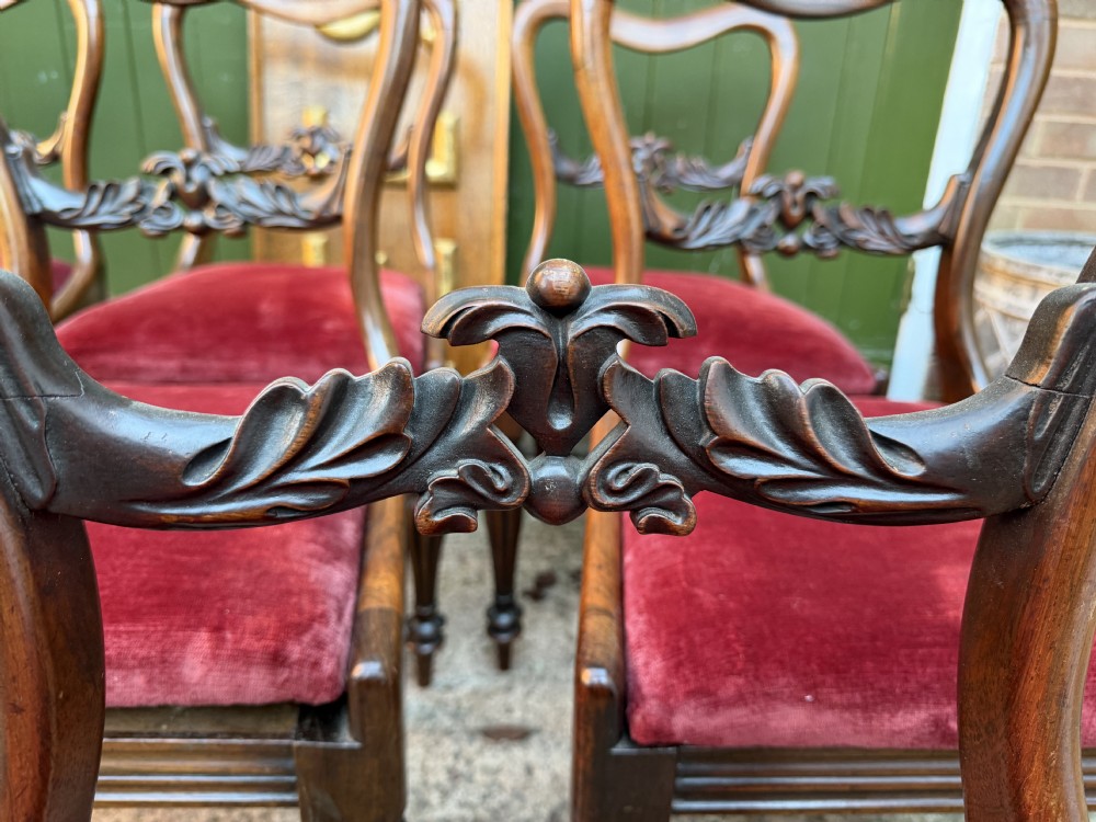 A set of eight early 19th-century William IV rosewood dining chairs with carved back rails, fluted front legs, and red velvet seats. View VII