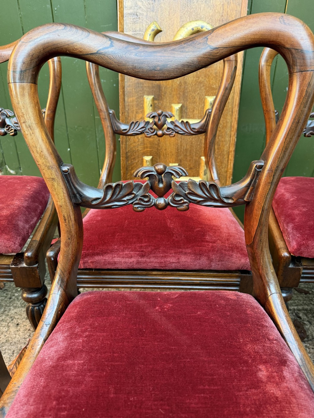 A set of eight early 19th-century William IV rosewood dining chairs with carved back rails, fluted front legs, and red velvet seats. View VIII
