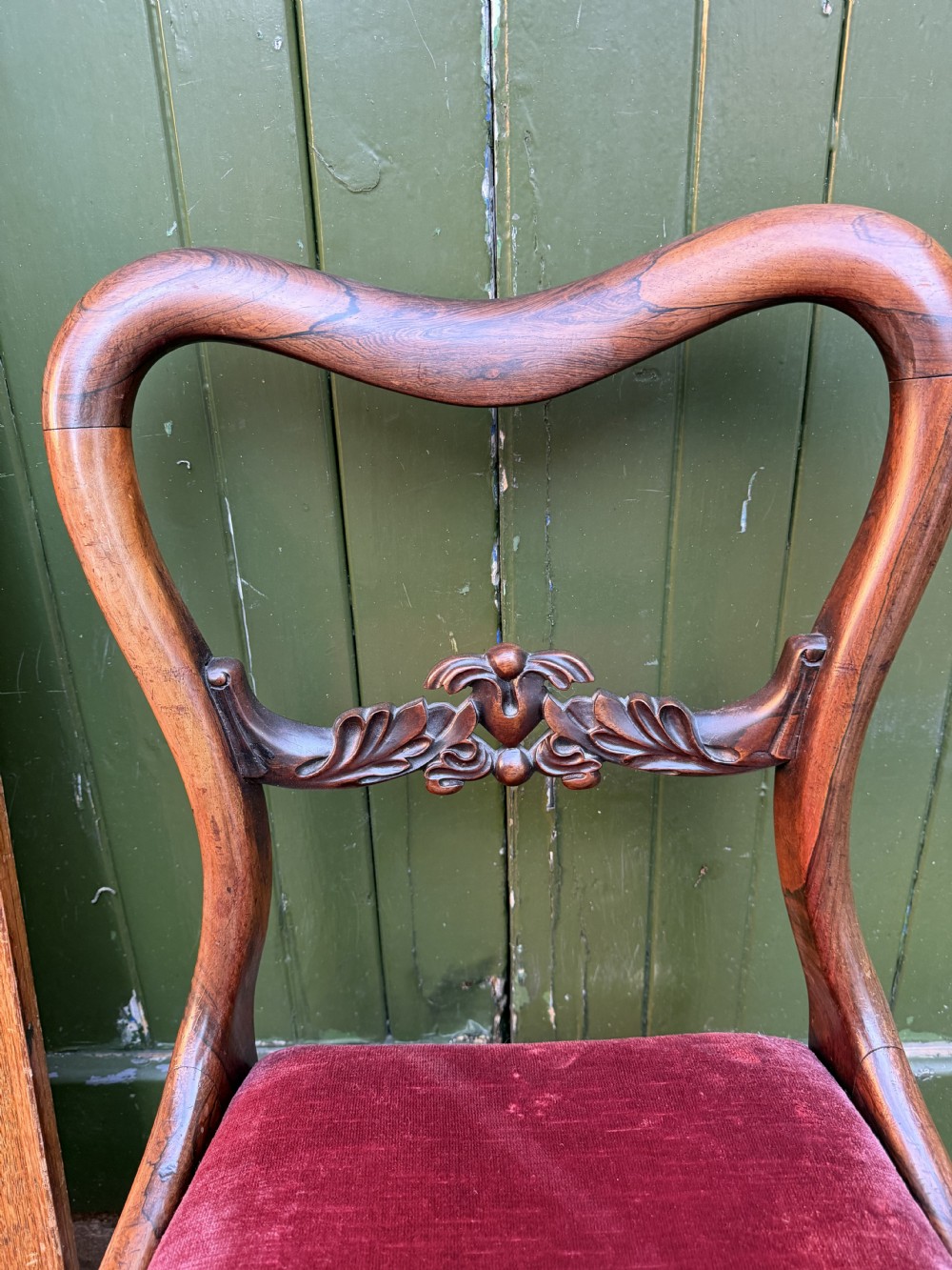 A set of eight early 19th-century William IV rosewood dining chairs with carved back rails, fluted front legs, and red velvet seats. View XIII