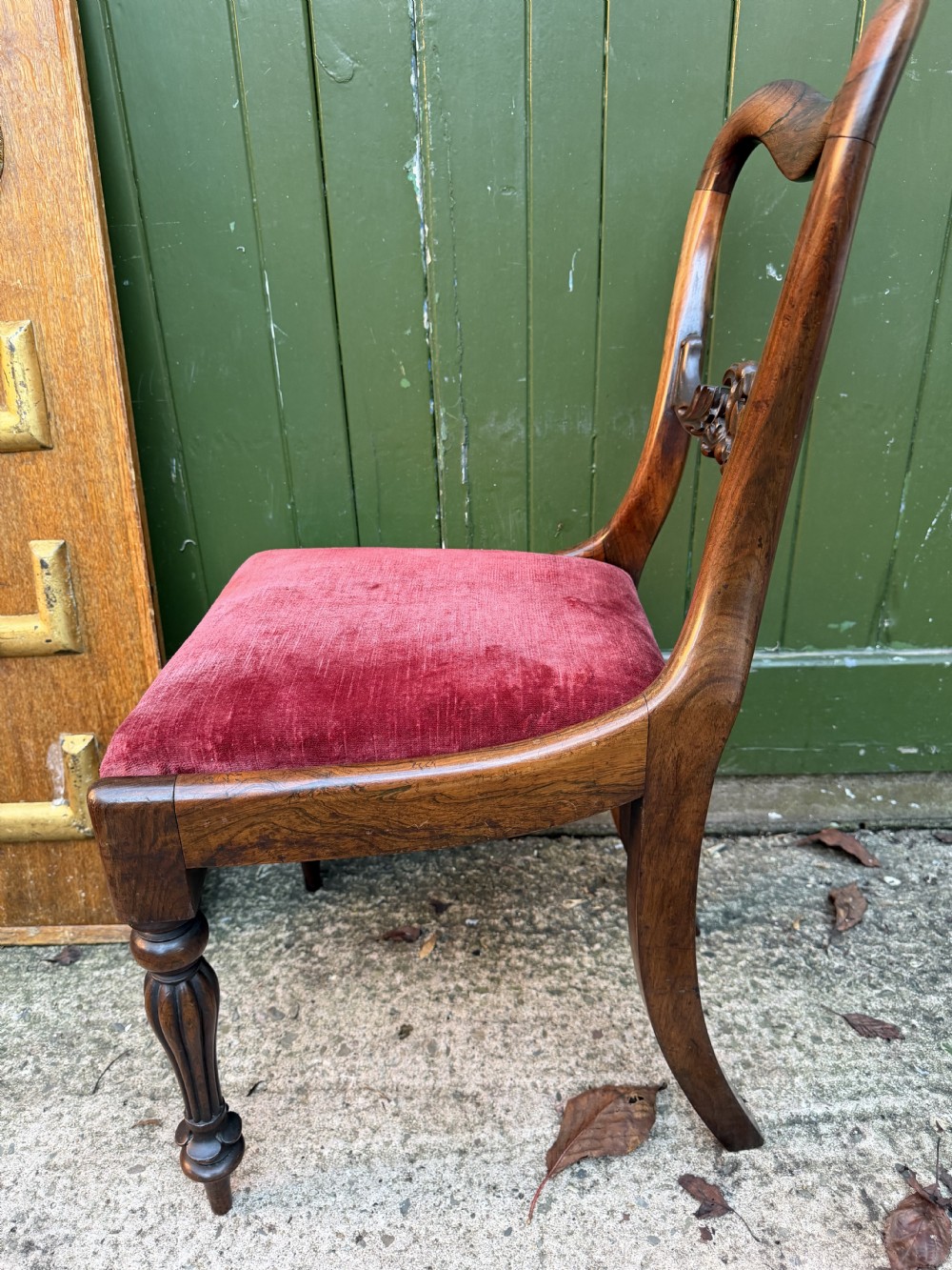 A set of eight early 19th-century William IV rosewood dining chairs with carved back rails, fluted front legs, and red velvet seats. View XIV