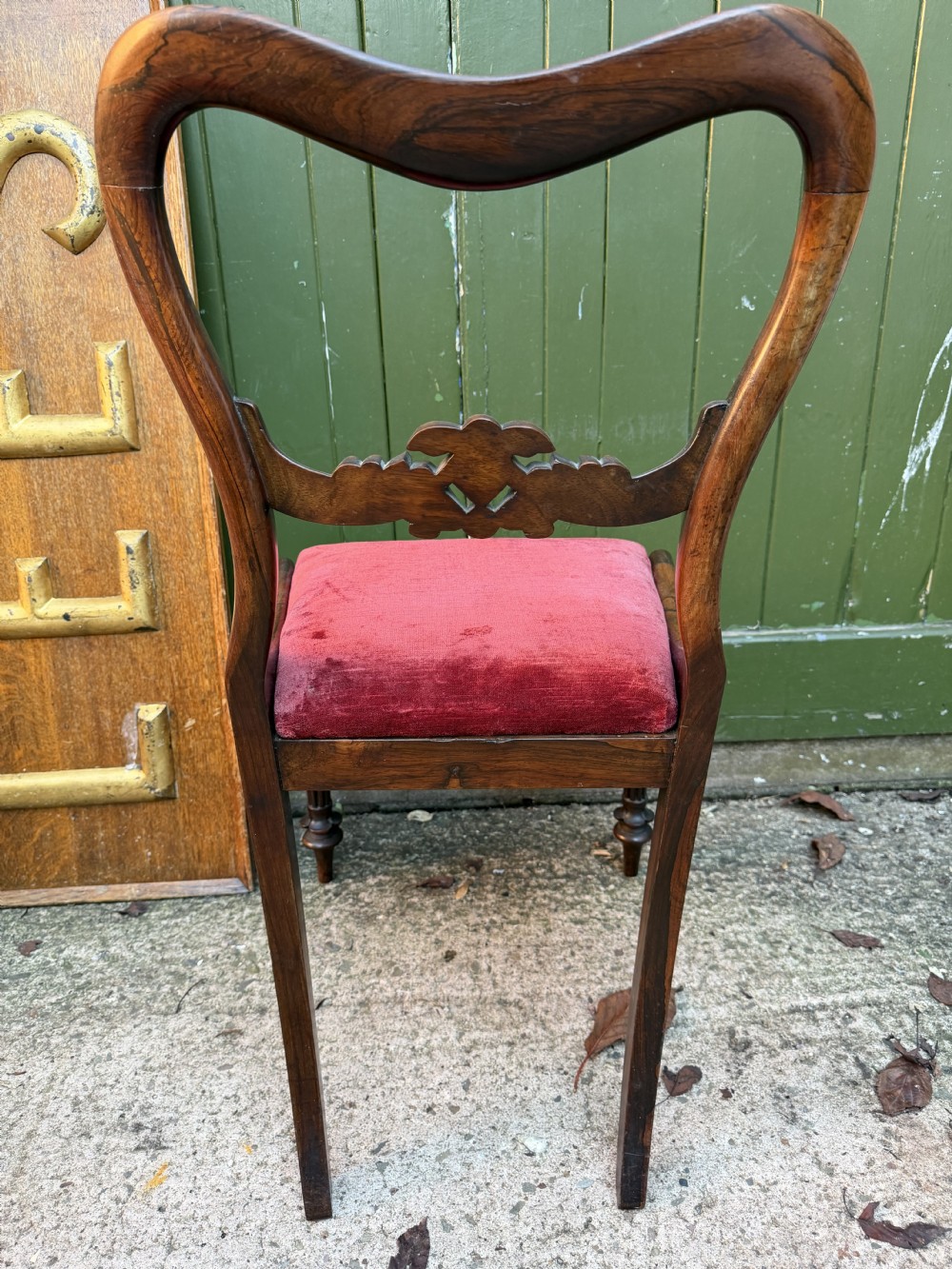 A set of eight early 19th-century William IV rosewood dining chairs with carved back rails, fluted front legs, and red velvet seats. View XV