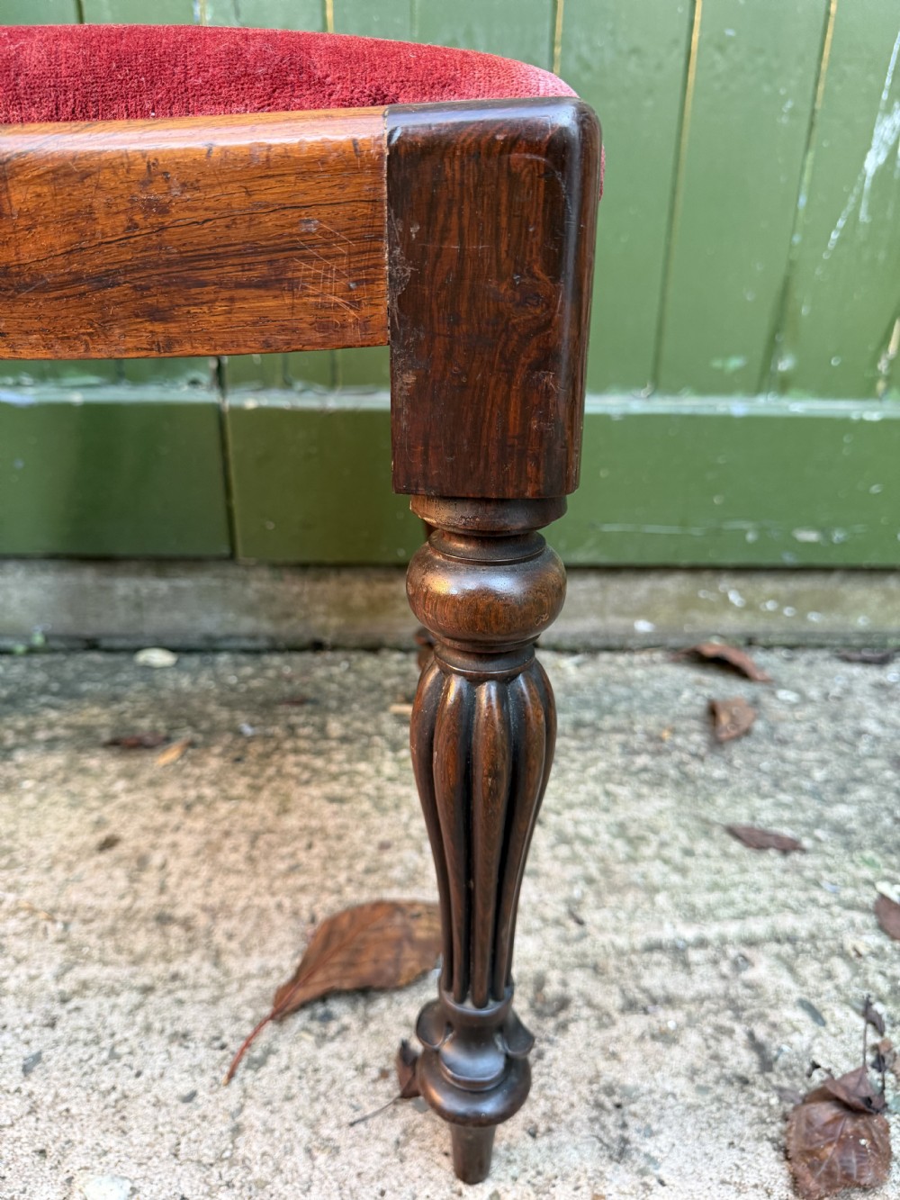 A set of eight early 19th-century William IV rosewood dining chairs with carved back rails, fluted front legs, and red velvet seats. View XVII