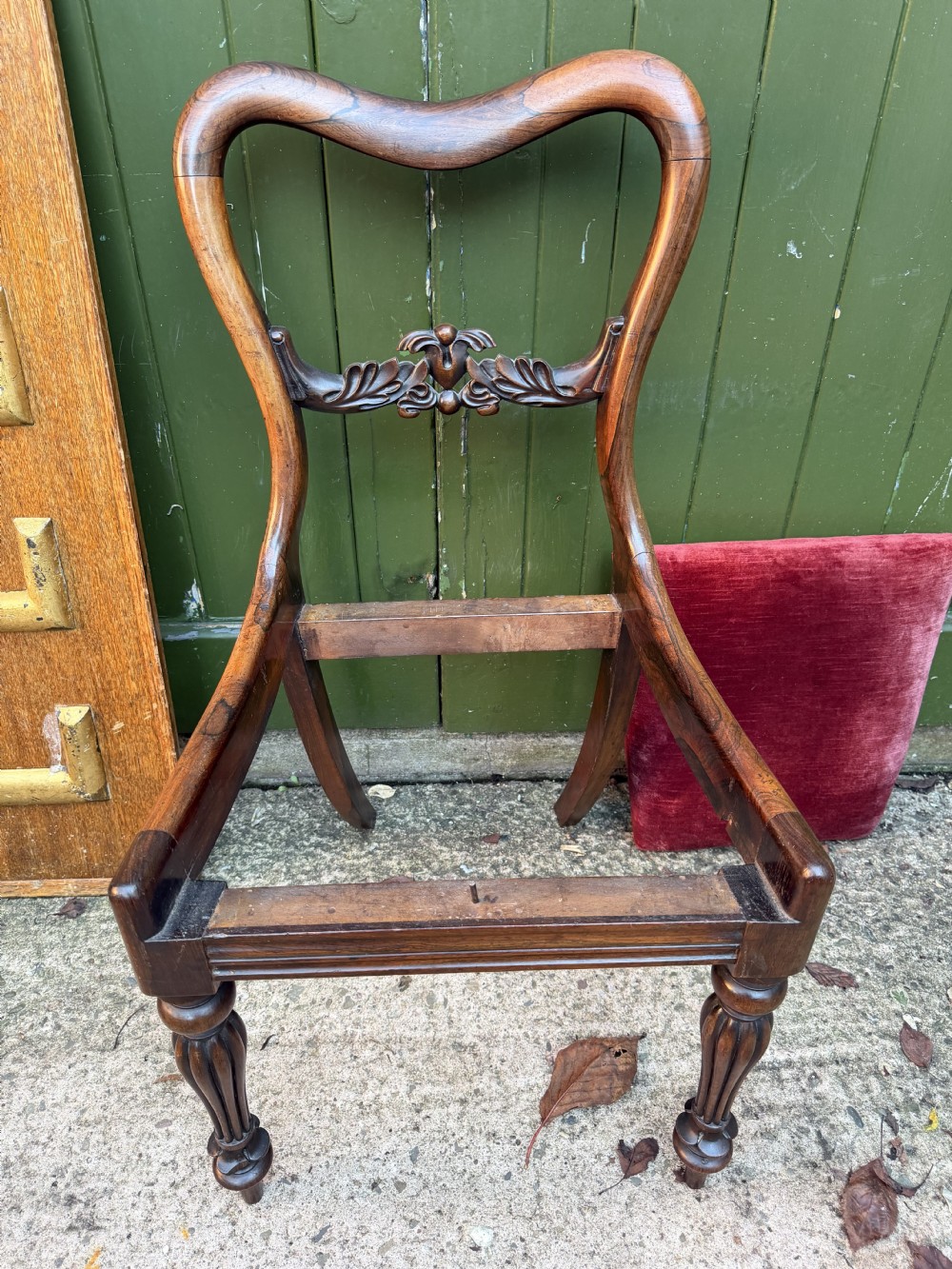 A set of eight early 19th-century William IV rosewood dining chairs with carved back rails, fluted front legs, and red velvet seats. View XVIII