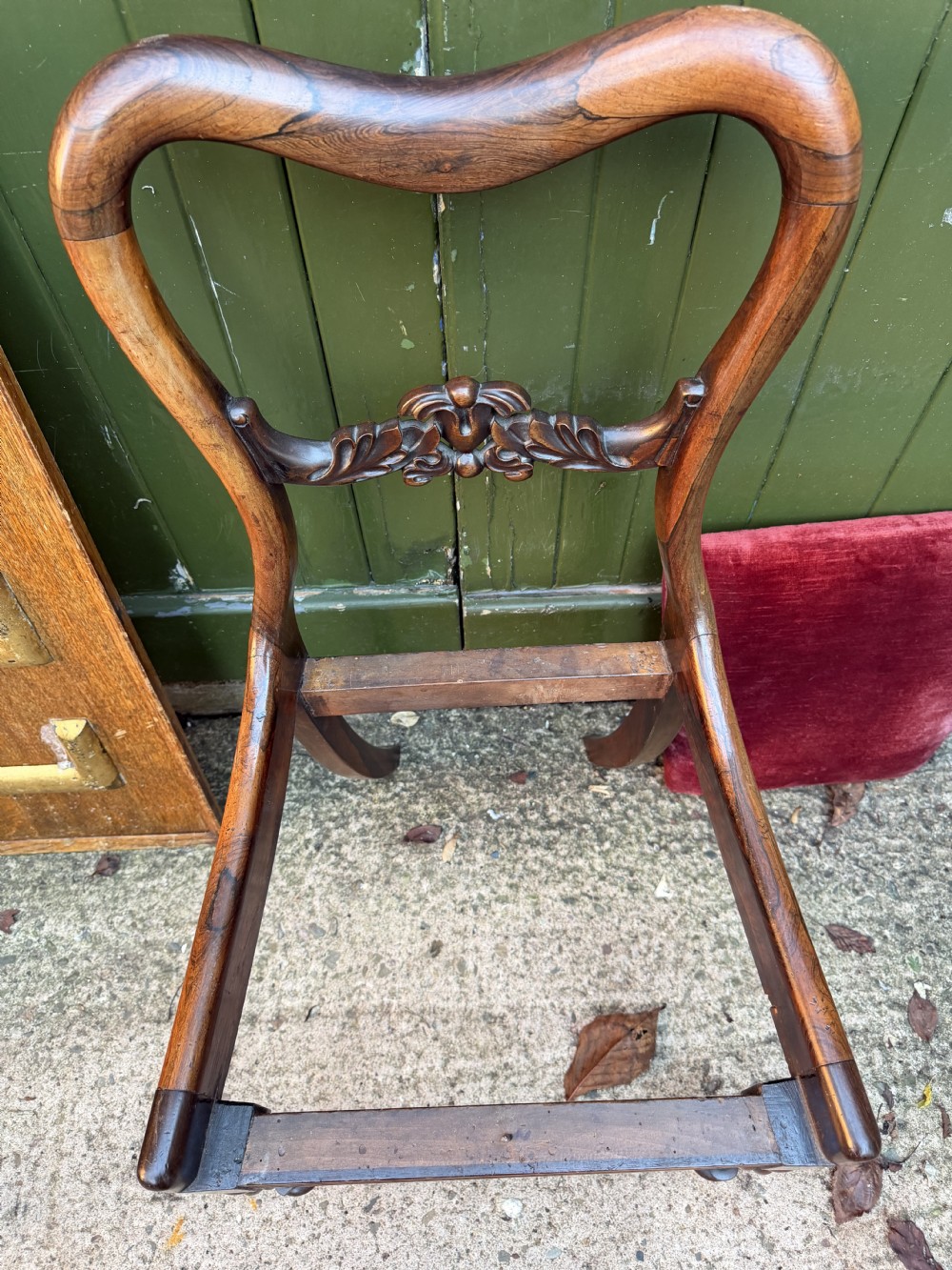 A set of eight early 19th-century William IV rosewood dining chairs with carved back rails, fluted front legs, and red velvet seats. View XIX