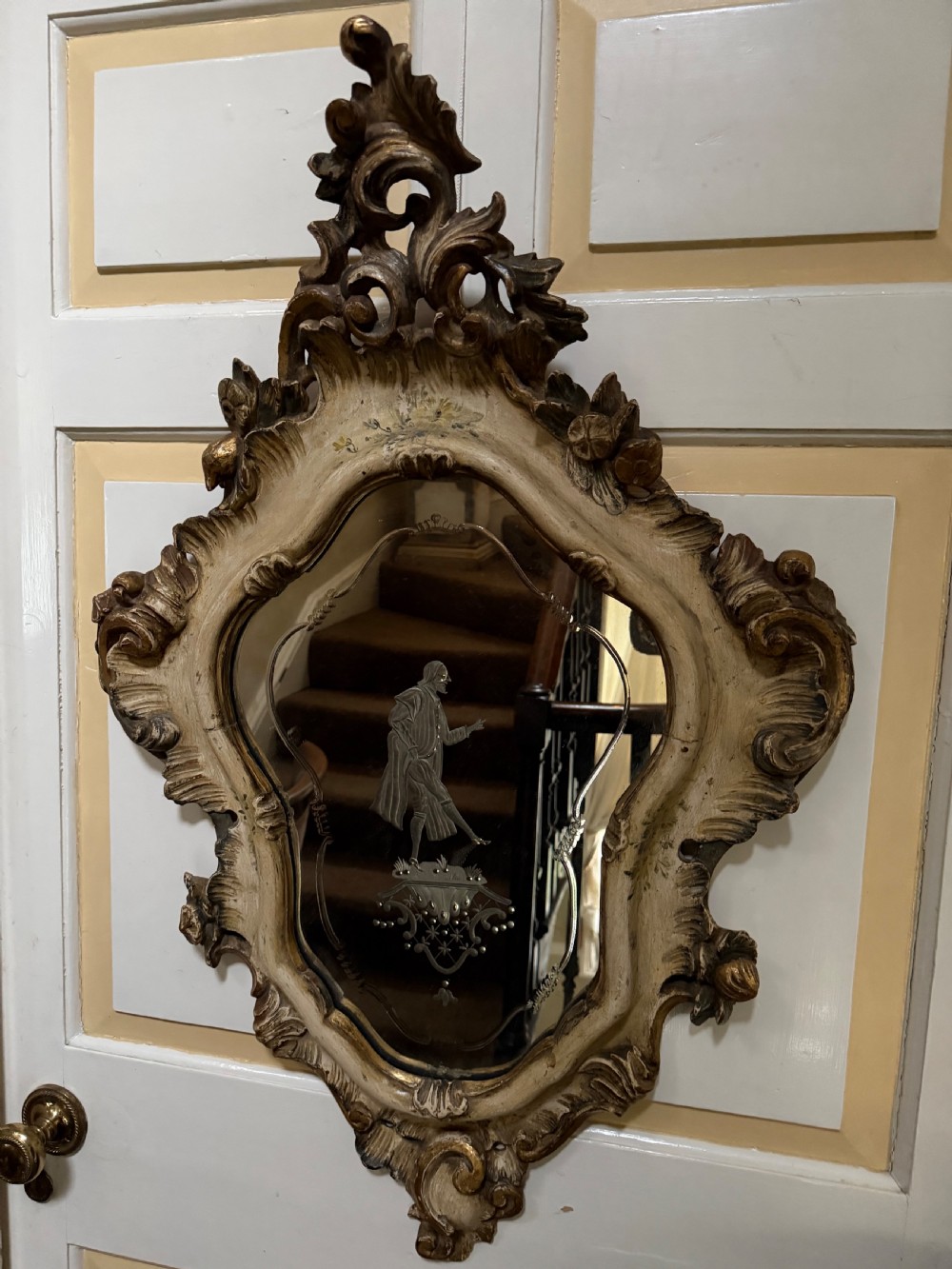 A pair of 19th-century Italian Venetian Rococo style wall mirrors featuring carved giltwood and polychrome frames surrounding etched glass depicting figures. View II