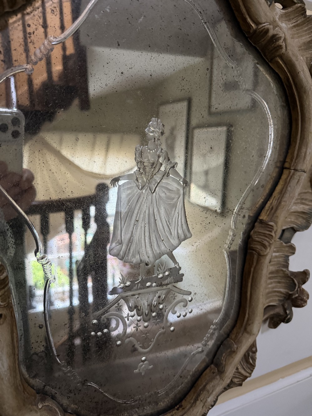 A pair of 19th-century Italian Venetian Rococo style wall mirrors featuring carved giltwood and polychrome frames surrounding etched glass depicting figures. View XI
