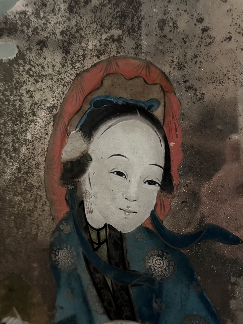 An early nineteenth-century Chinese export reverse glass picture featuring a figure on a boat against a silvered mirror background, encased in a dark wooden frame with beaded inner moulding. View XII