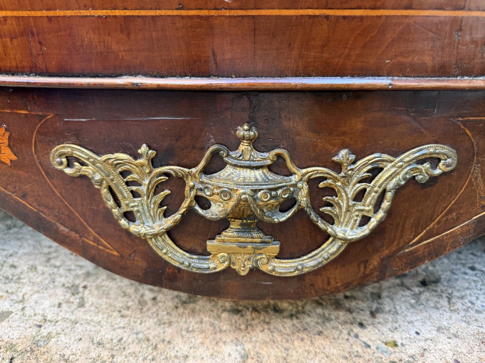 An antique Dutch walnut bureau with floral marquetry inlays, a curved cylinder front, three drawers, and decorative brass handles. View IX