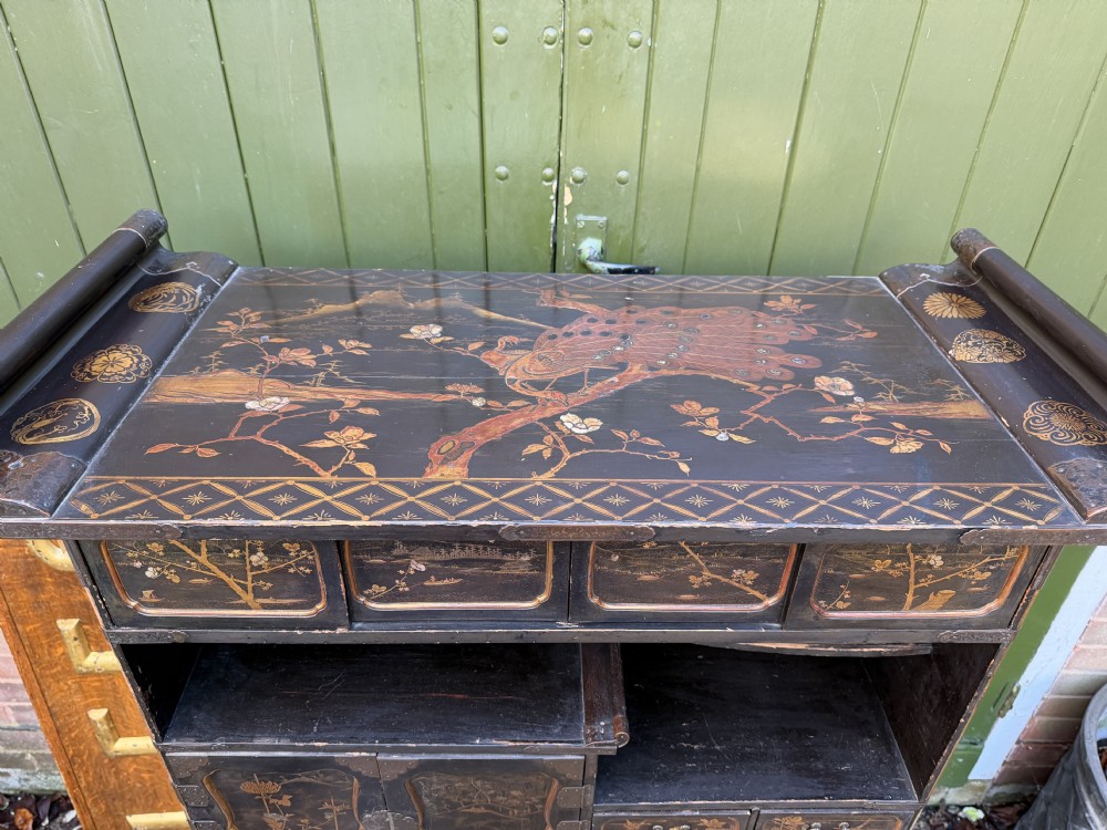 Late nineteenth-century Japanese Meiji period black lacquer shodana cabinet-on-stand with gold maki-e pictorial panels, asymmetrical shelves, and engraved metal fitments. View V