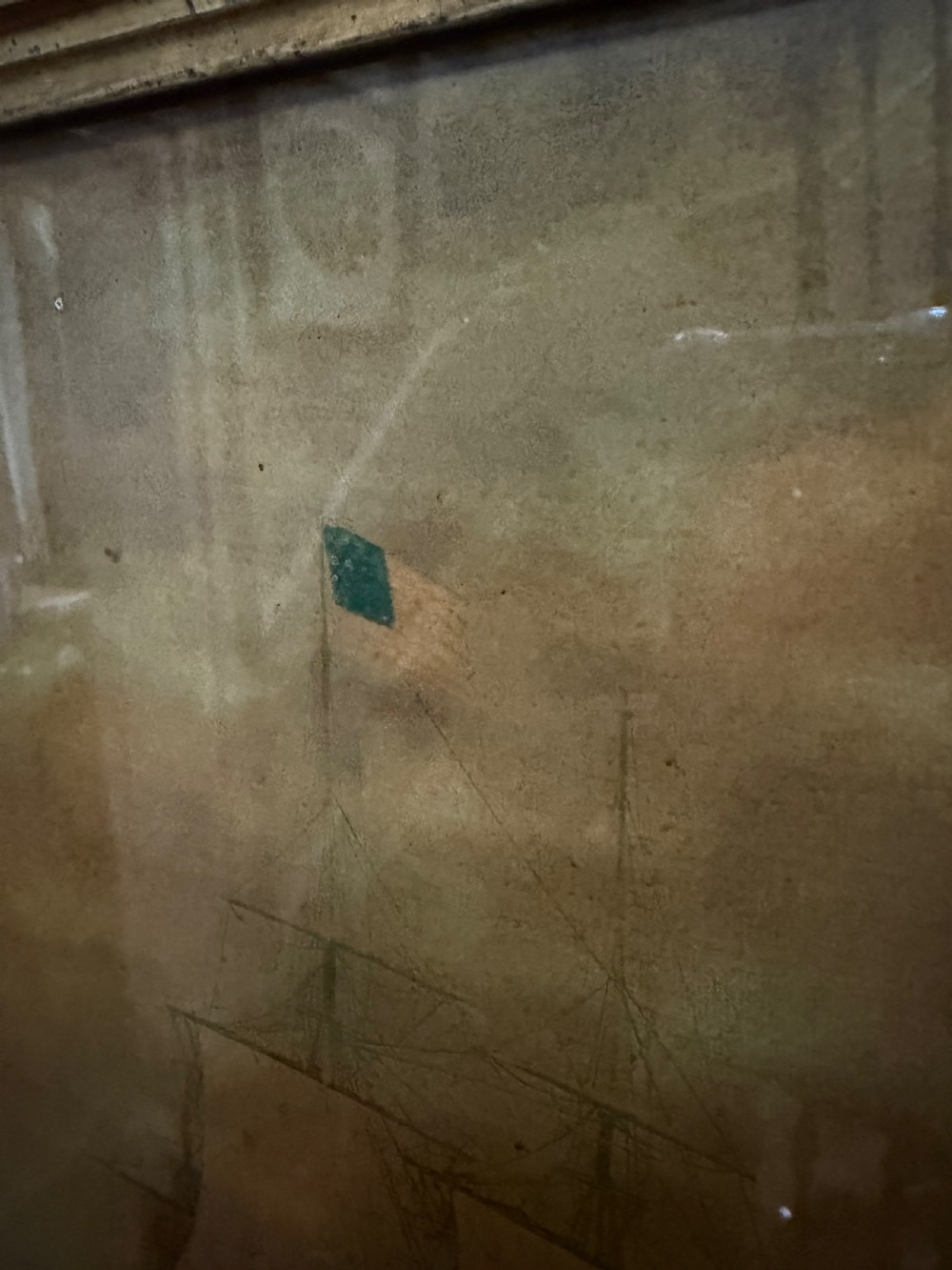 An early nineteenth-century rectangular maple-framed divided mirror featuring a reverse glass print of a naval engagement in the upper section and a reflective mirror below. View V