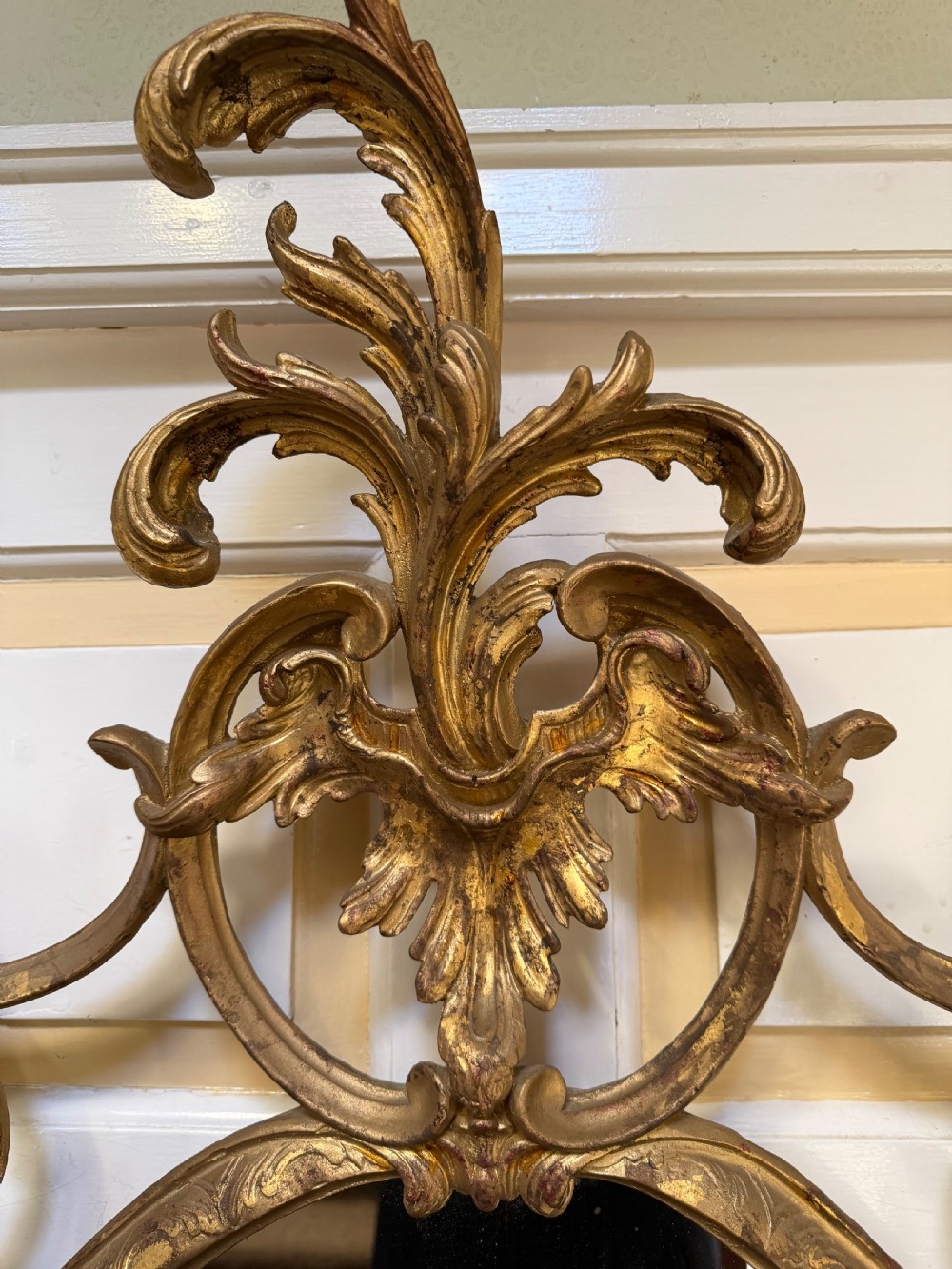 Flamboyant early C20th carved gilt-wood and composition rococo-style framed oval mirror of C18th period design in the manner of Thomas Chippendale. View III
