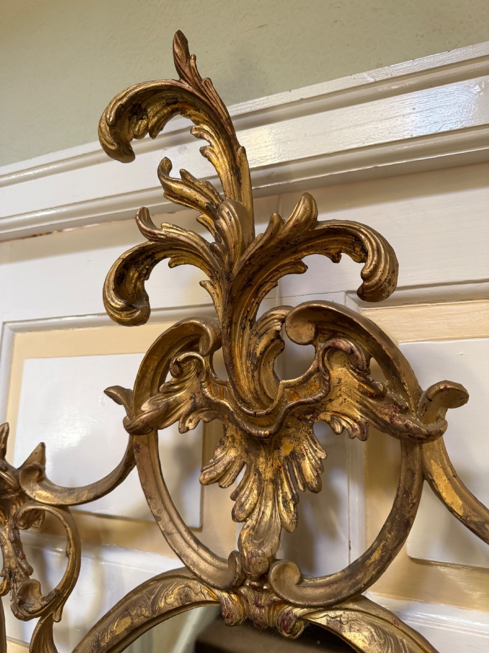 Flamboyant early C20th carved gilt-wood and composition rococo-style framed oval mirror of C18th period design in the manner of Thomas Chippendale. View VII