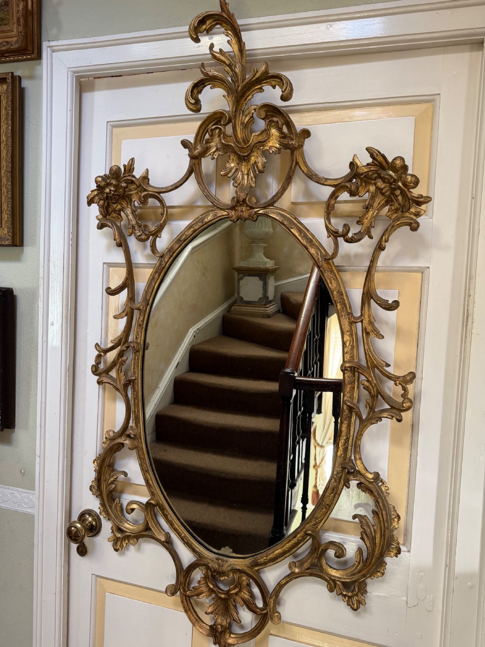 Flamboyant early C20th carved gilt-wood and composition rococo-style framed oval mirror of C18th period design in the manner of Thomas Chippendale. View IX