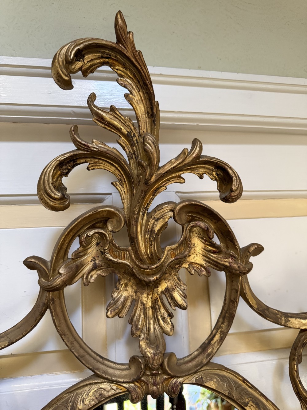 Flamboyant early C20th carved gilt-wood and composition rococo-style framed oval mirror of C18th period design in the manner of Thomas Chippendale. View XVIII