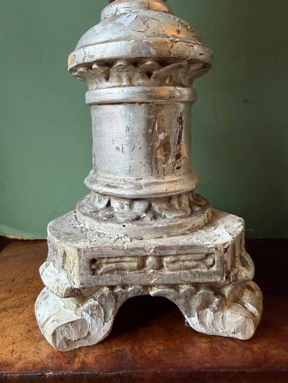 Pair of tall, hand-carved wooden altar candlesticks with an aged silver leaf finish, leaf motifs, and architectural bases. View III