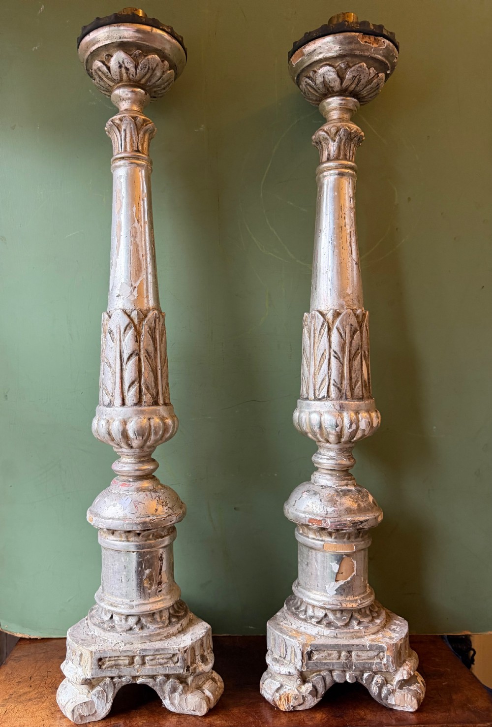 Pair of tall, hand-carved wooden altar candlesticks with an aged silver leaf finish, leaf motifs, and architectural bases. View IV