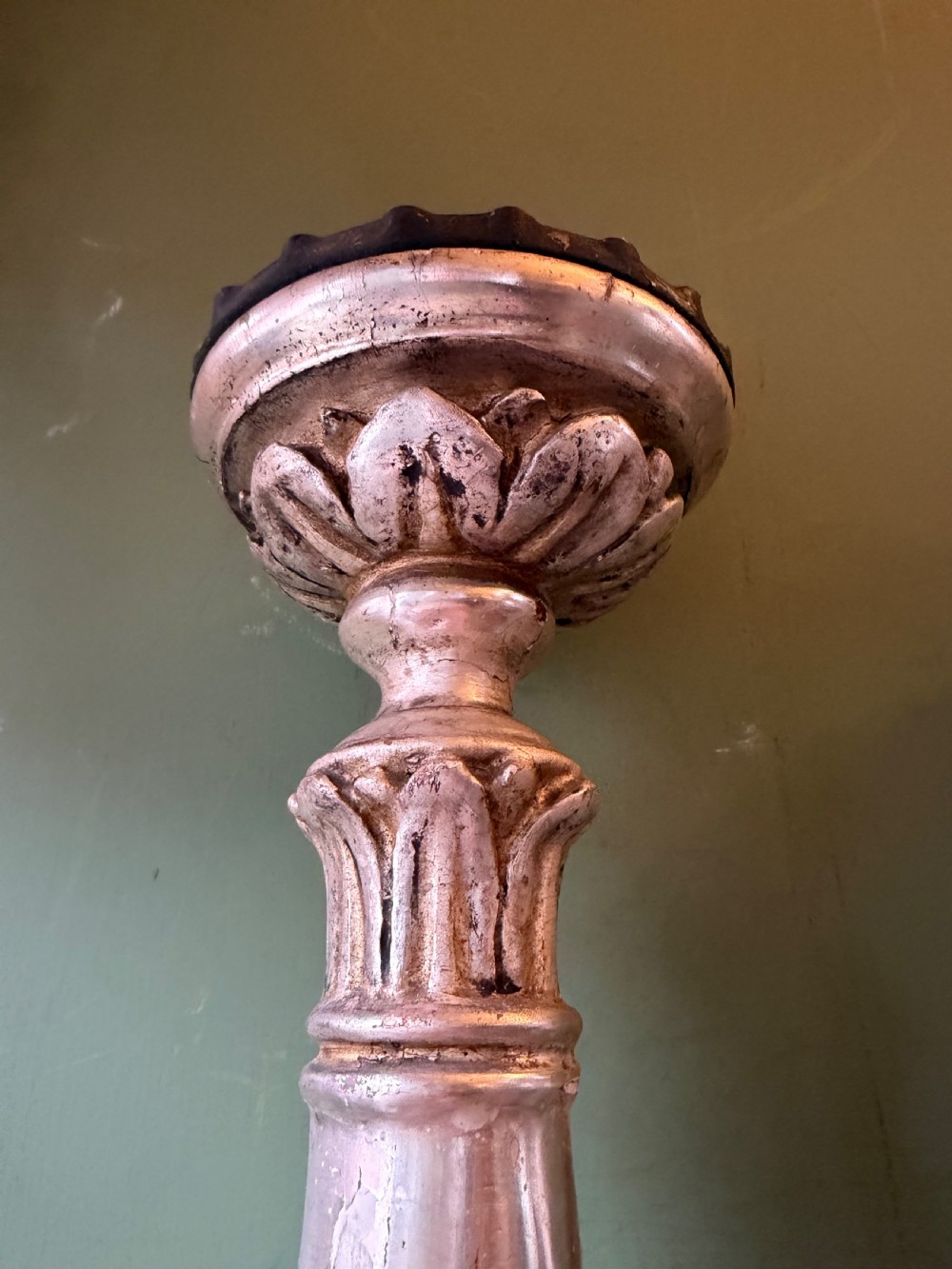 Pair of tall, hand-carved wooden altar candlesticks with an aged silver leaf finish, leaf motifs, and architectural bases. View VI