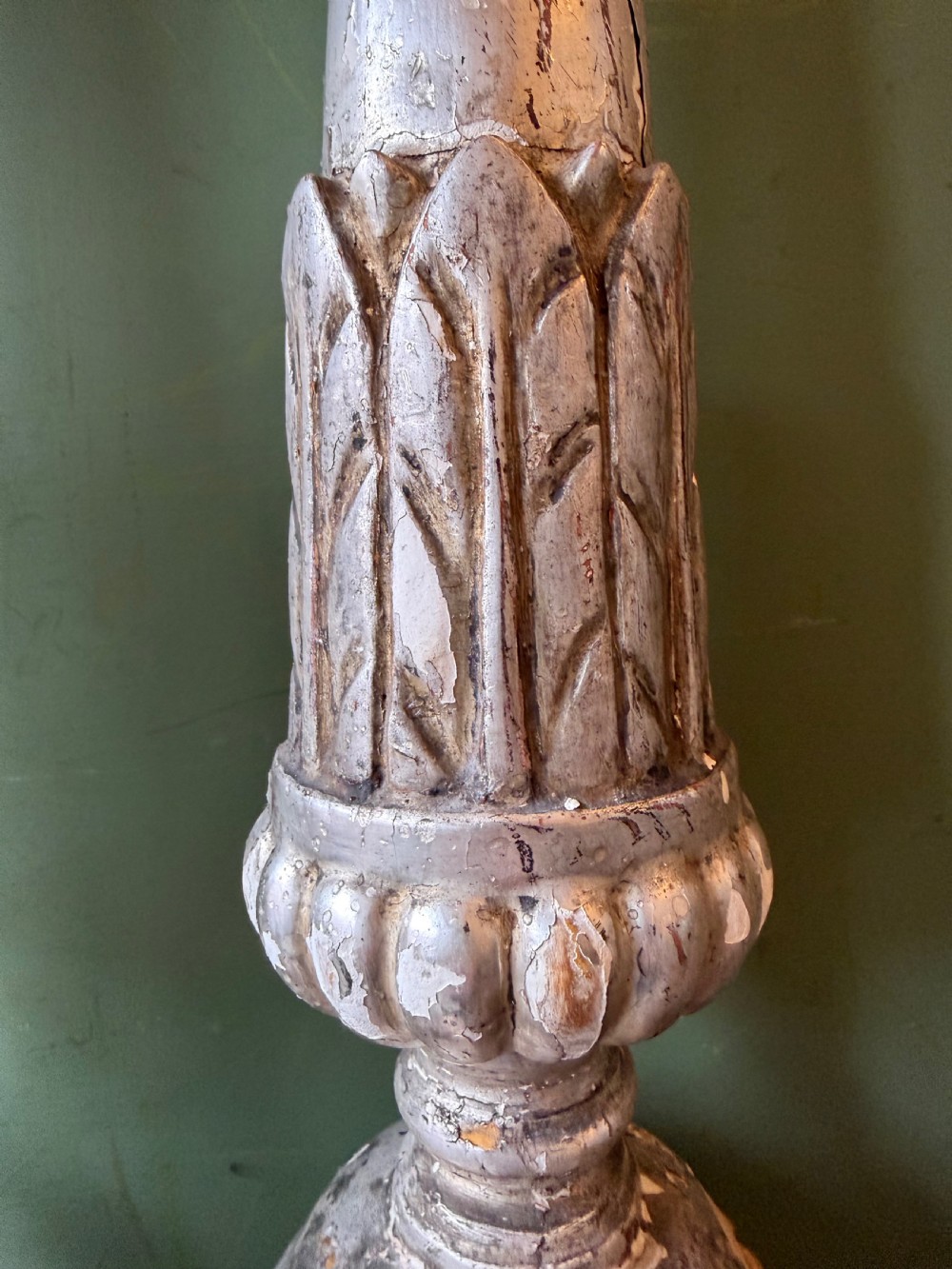 Pair of tall, hand-carved wooden altar candlesticks with an aged silver leaf finish, leaf motifs, and architectural bases. View VIII