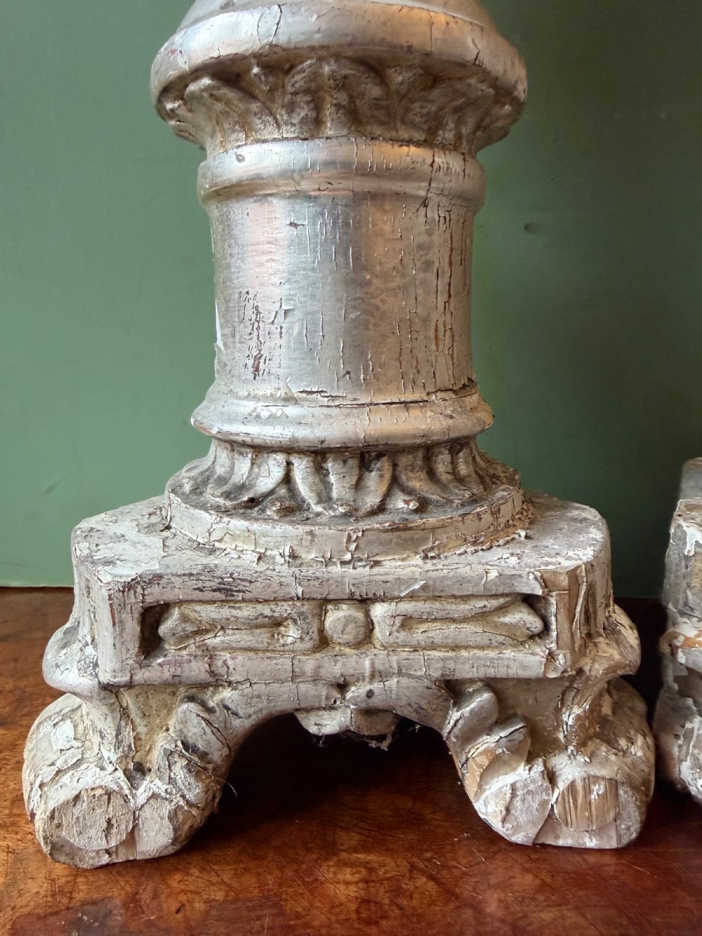 Pair of tall, hand-carved wooden altar candlesticks with an aged silver leaf finish, leaf motifs, and architectural bases. View IX
