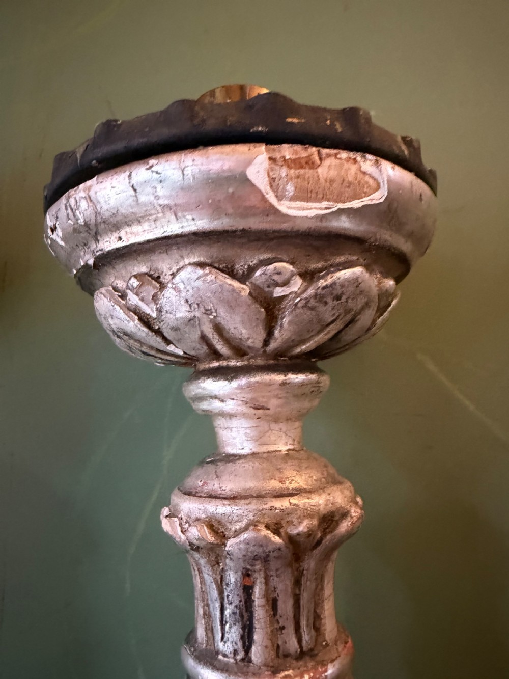 Pair of tall, hand-carved wooden altar candlesticks with an aged silver leaf finish, leaf motifs, and architectural bases. View X