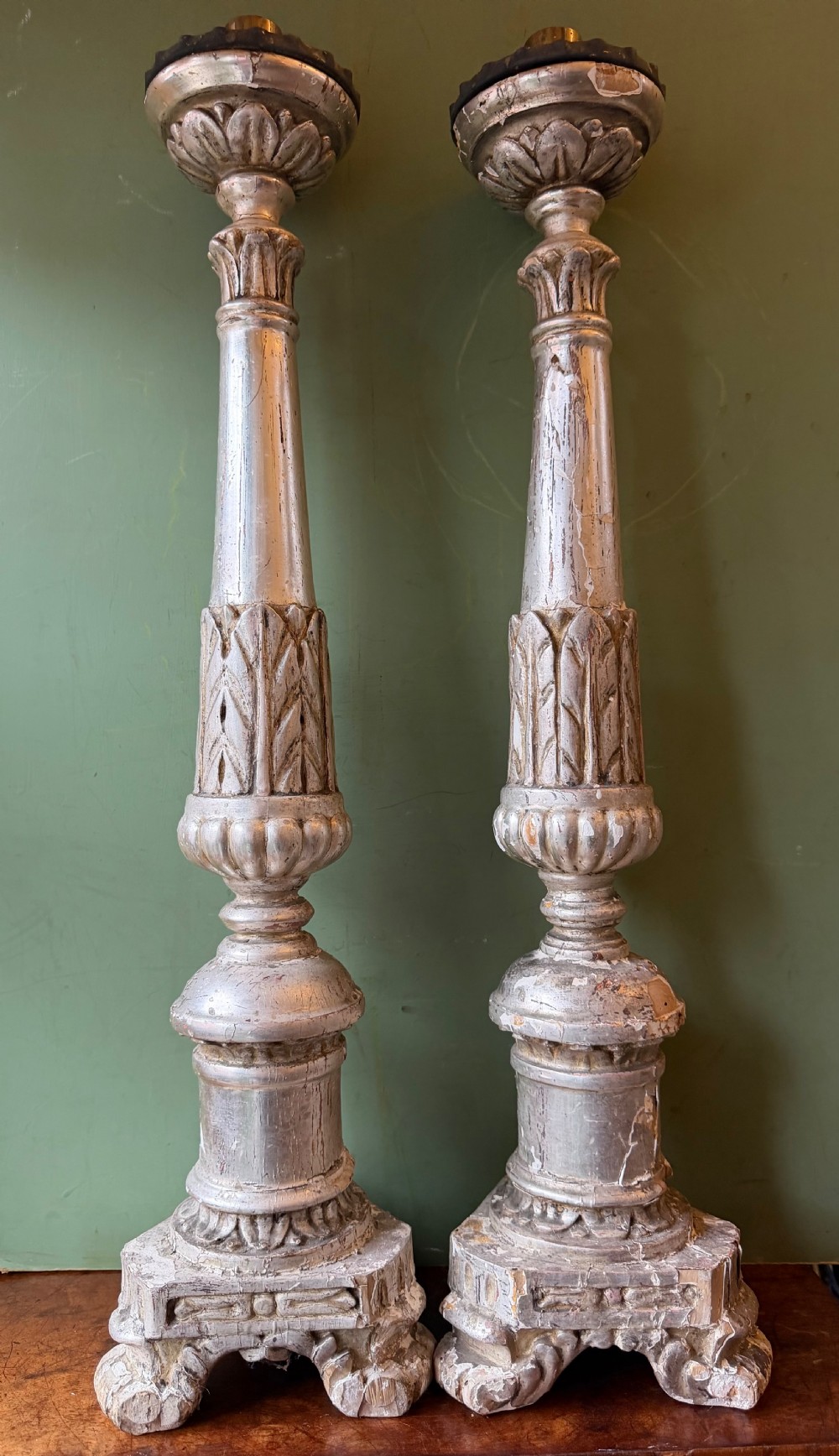 Pair of tall, hand-carved wooden altar candlesticks with an aged silver leaf finish, leaf motifs, and architectural bases. View XI
