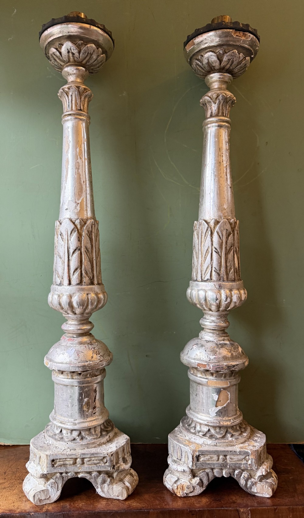 Pair of tall, hand-carved wooden altar candlesticks with an aged silver leaf finish, leaf motifs, and architectural bases. View XIII