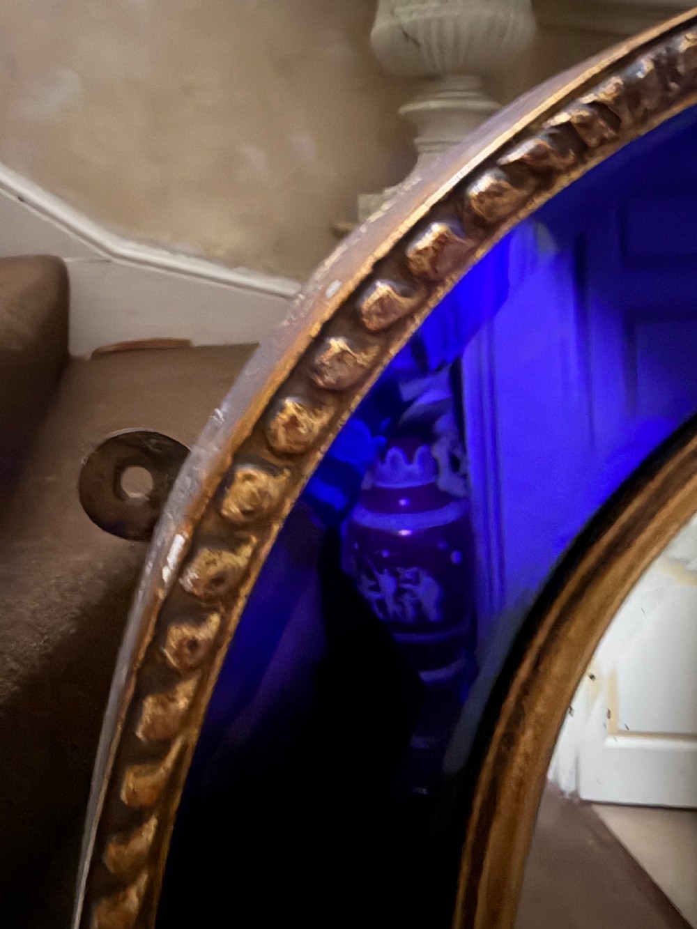A late 19th-century wall mirror featuring a shaped arched top, cobalt blue glass margin borders, and an ornate gilded inner and outer moulding. View III